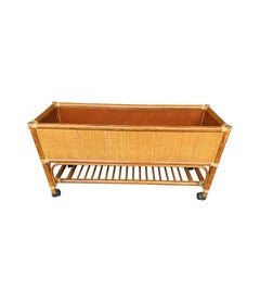 A pair of large Italian 1970s bamboo and rattan planters on castors