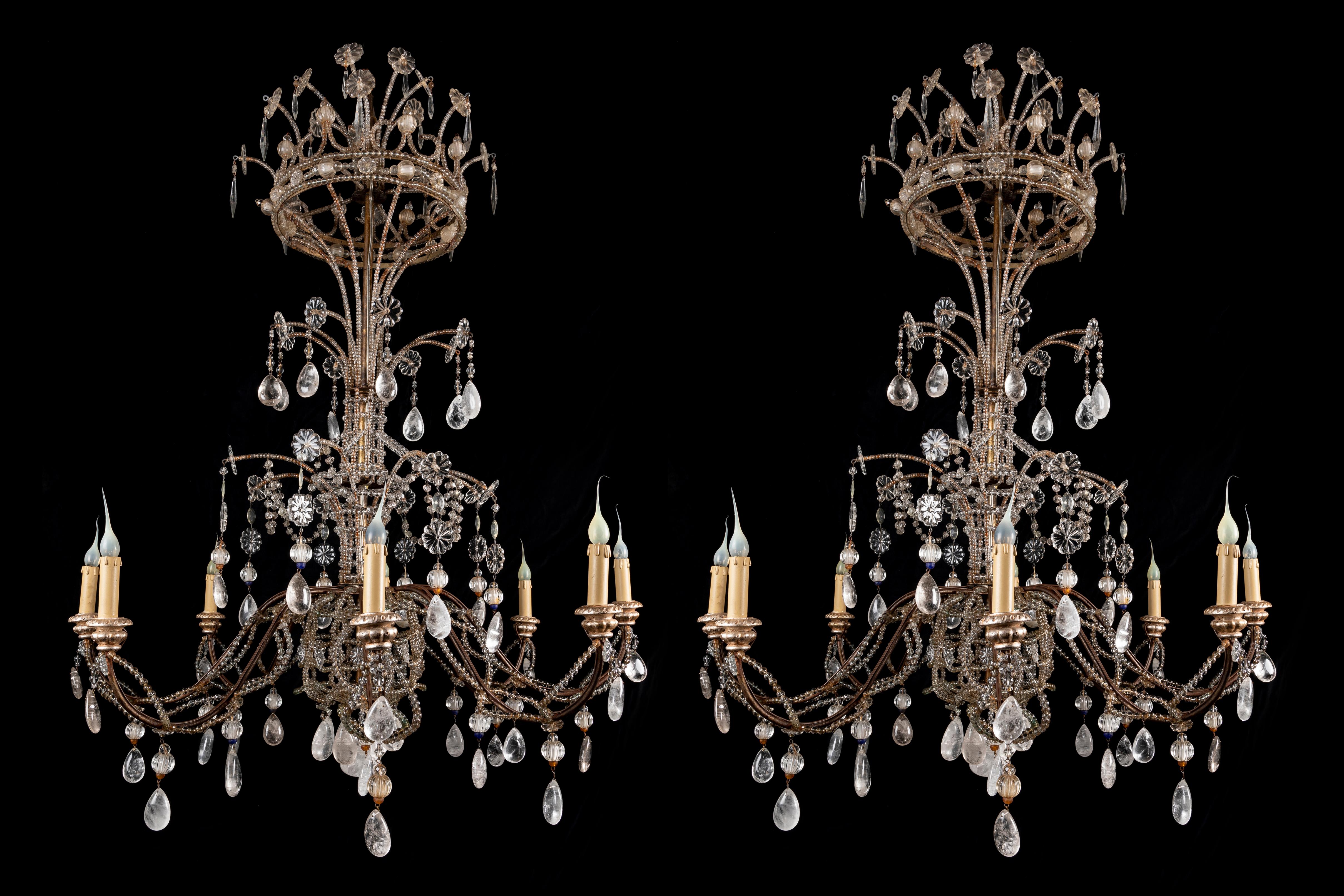 A Pair of very large and extremely unusual French Maison Bagues style cut rock crystal, beaded glass and cut crystal multi light triple tier chandeliers of exquisite craftsmanship. This exquisite pair of rock crystal chandeliers are embellished with