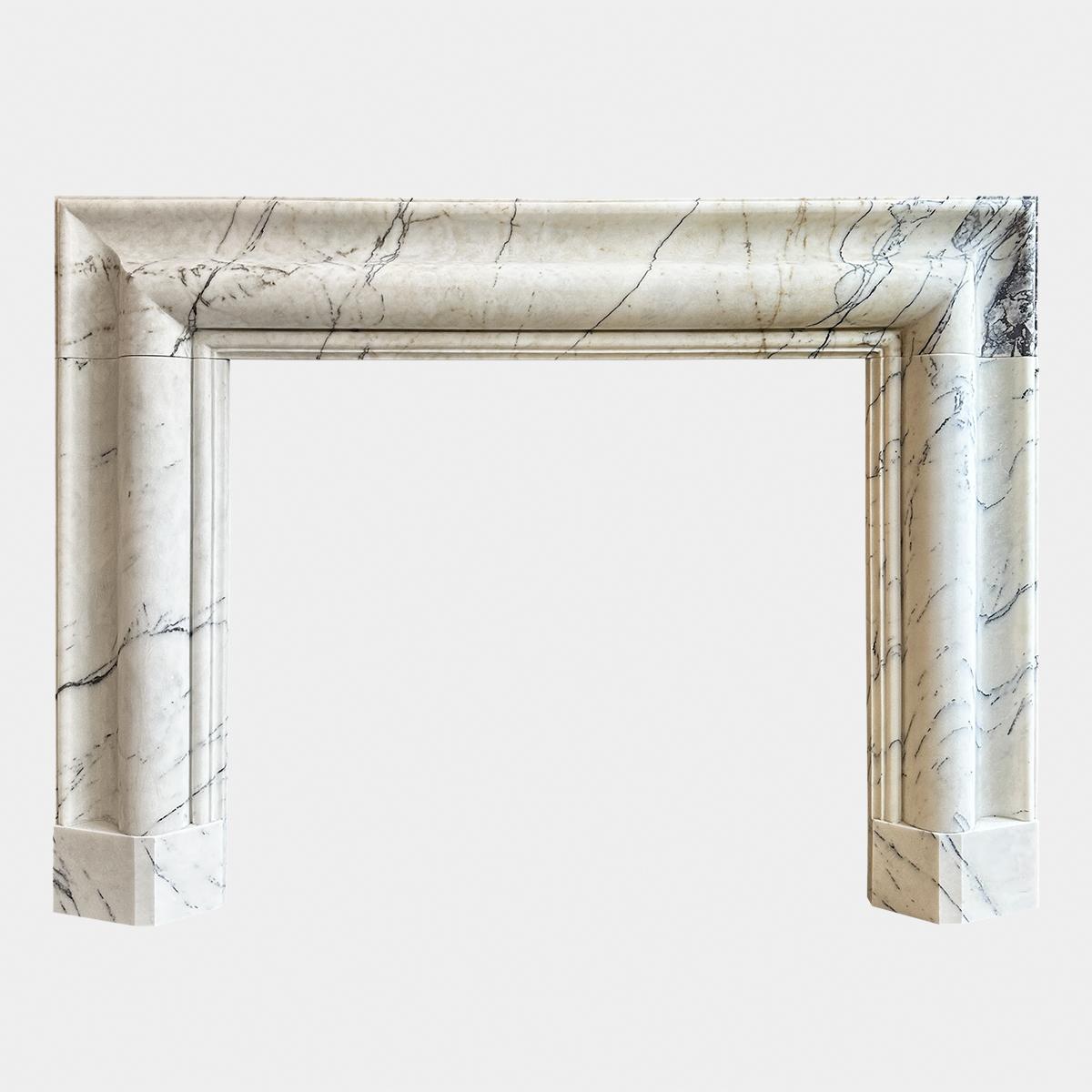 A pair of large substantial reclaimed bolection fireplaces from Italy, executed in a form of Carrara marble known as Calacatta Vagli . Pale background colours with gold tones and hues with stricking purple and grey veins. Wide framed, stood on