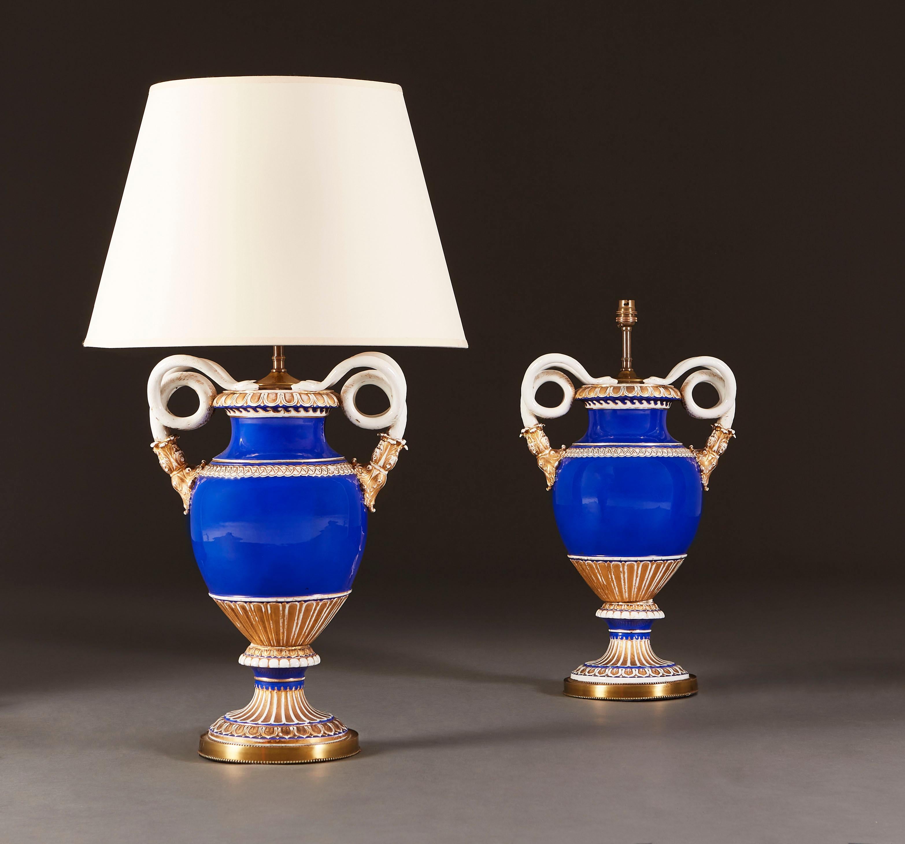 An unusual pair of large Meissen table lamps with scroll arms decorated with a blue glaze and gilding throughout.

Currently wired for the UK. Please enquire for rewiring services.

Please note: Lampshades not included.
