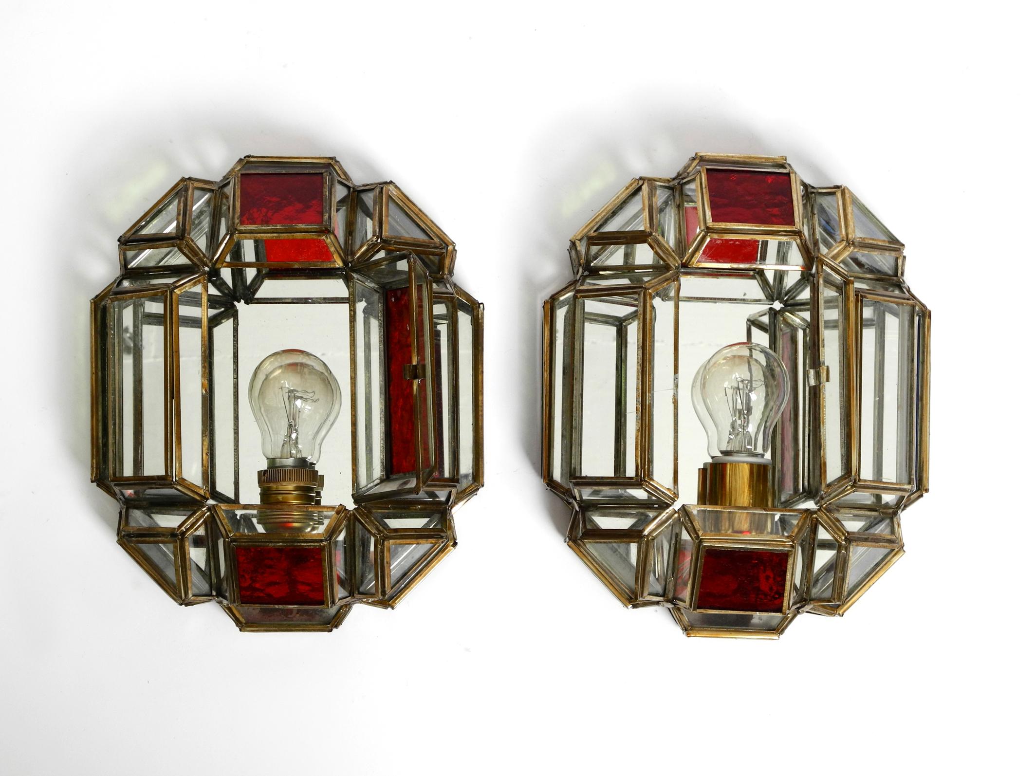 A pair of beautiful large Mid Century stained glasses Grenadina sconces with brass bases.
Great elaborate design made by hand. Made in Spain.
Both lamps identical with transparent, red, green and blue glasses and mirrored on the inside.
The back
