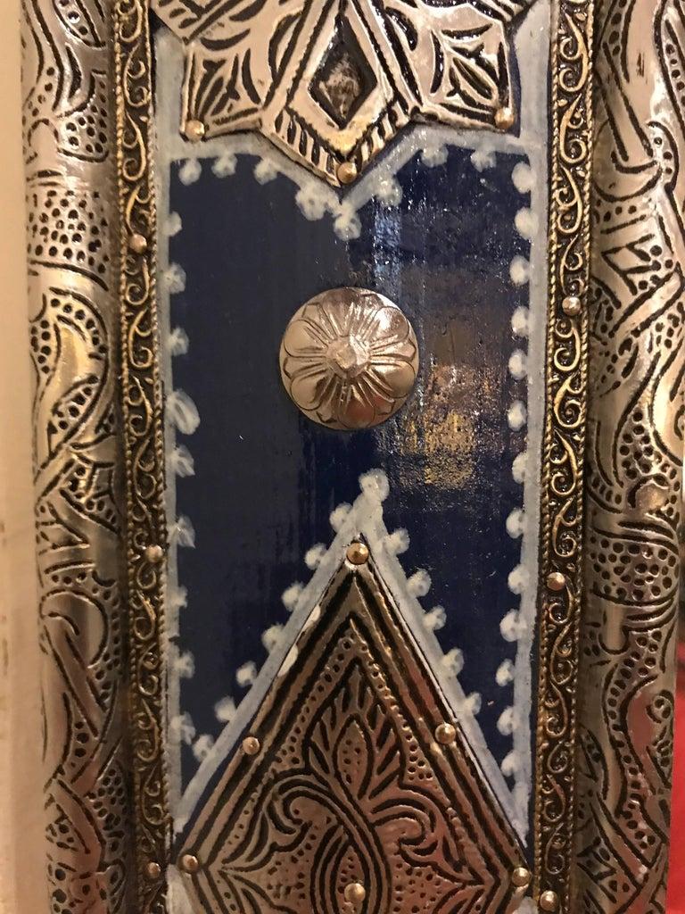 A large pair of Moroccan Moorish style blue mirrors. The design and color of this impressive pair of mirrors are inspired by the blue city (Chaouen) in north of Morocco. Featuring silver metal filigree work, this pair of mirrors is a sumptuous and