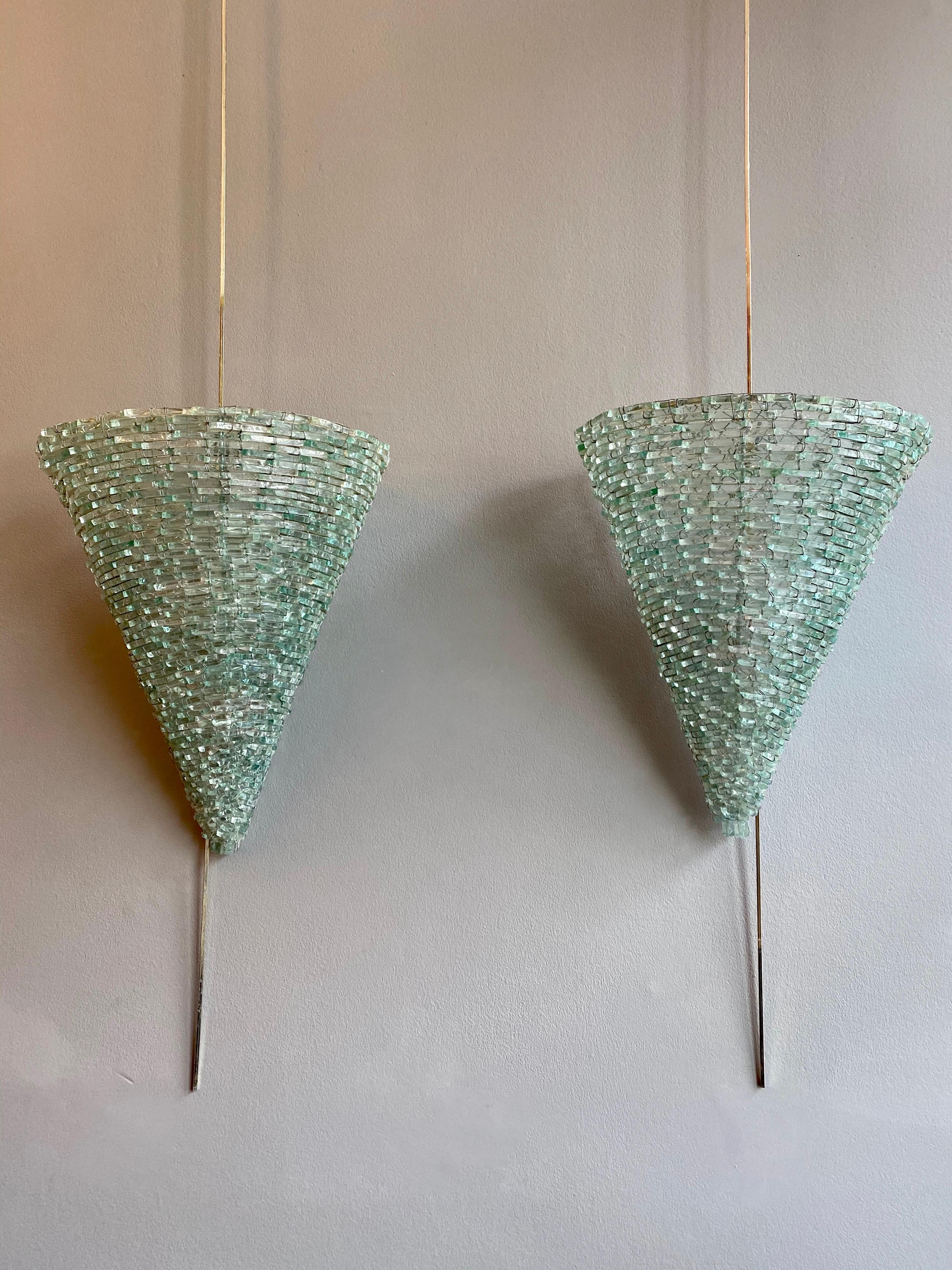 An unusual stylized pair of cone shaped Murano glass wall lights. Built up of small cut pieces on a metal frame, Italian, circa 1960s.