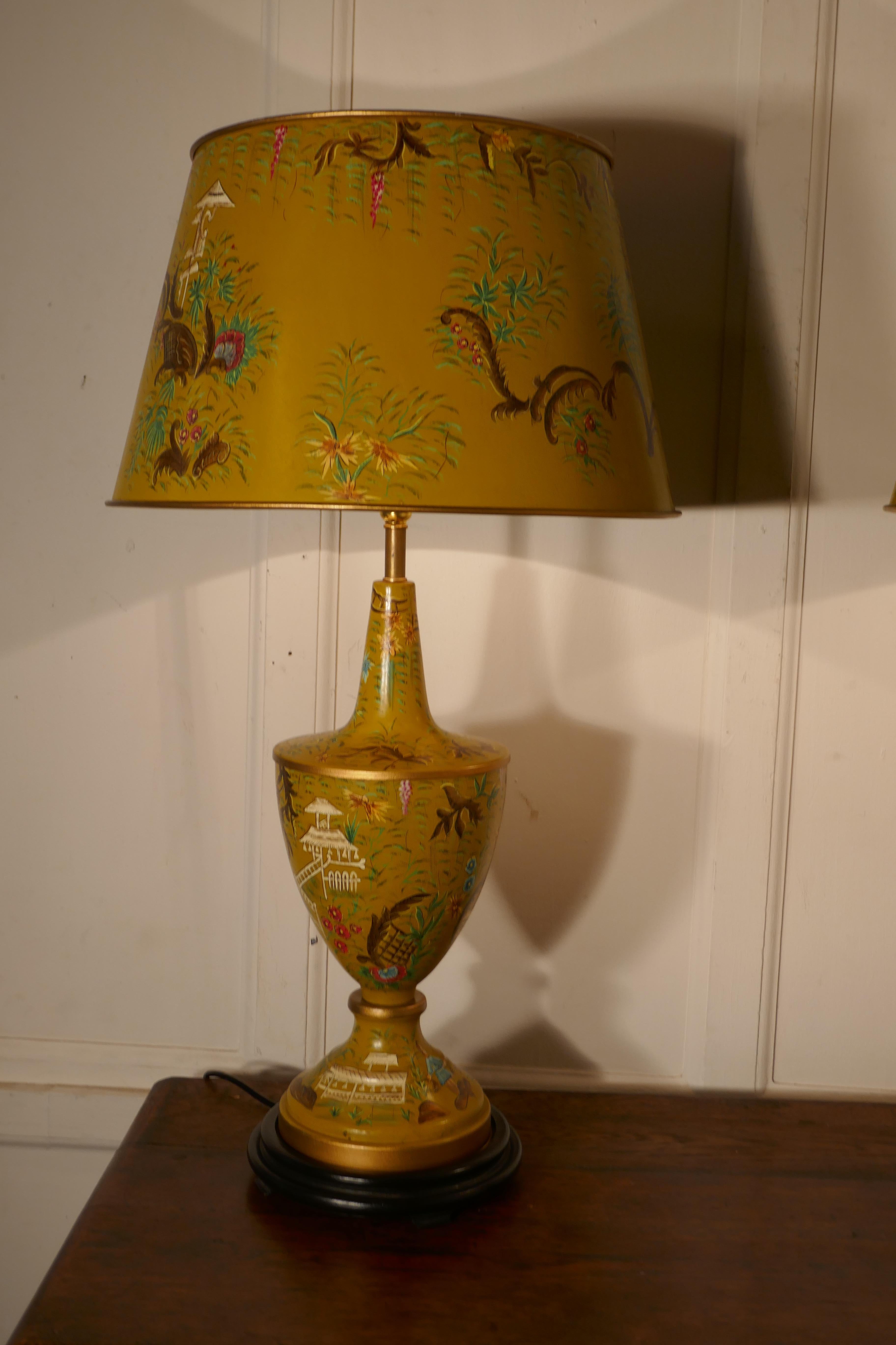 A pair of large mustard yellow chinoiserie toleware table lamps

The large stunning lamps have matching shades, both lamps and shades have a crackle glaze finish and are hand painted with both color and gold detail
The lamps are fully wired and
