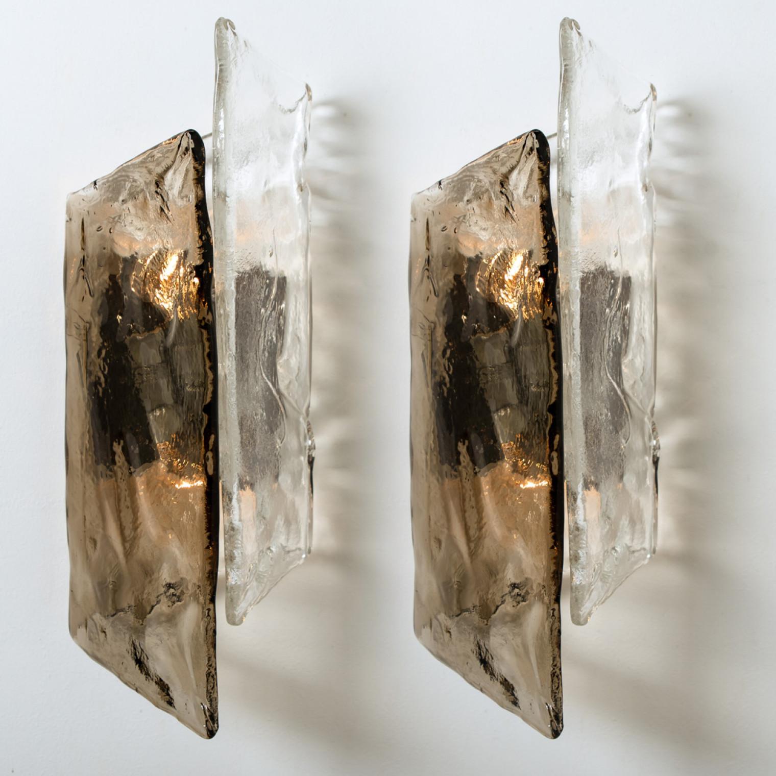 Beautiful and large murano glass wall sconces or lights by Carlo Nason, Austria, 1970s. A white lacquered metal backplate holds and hand blown and smoked bubble glass shades. Each Wall light takes two small base bulbs up to max. 40W per