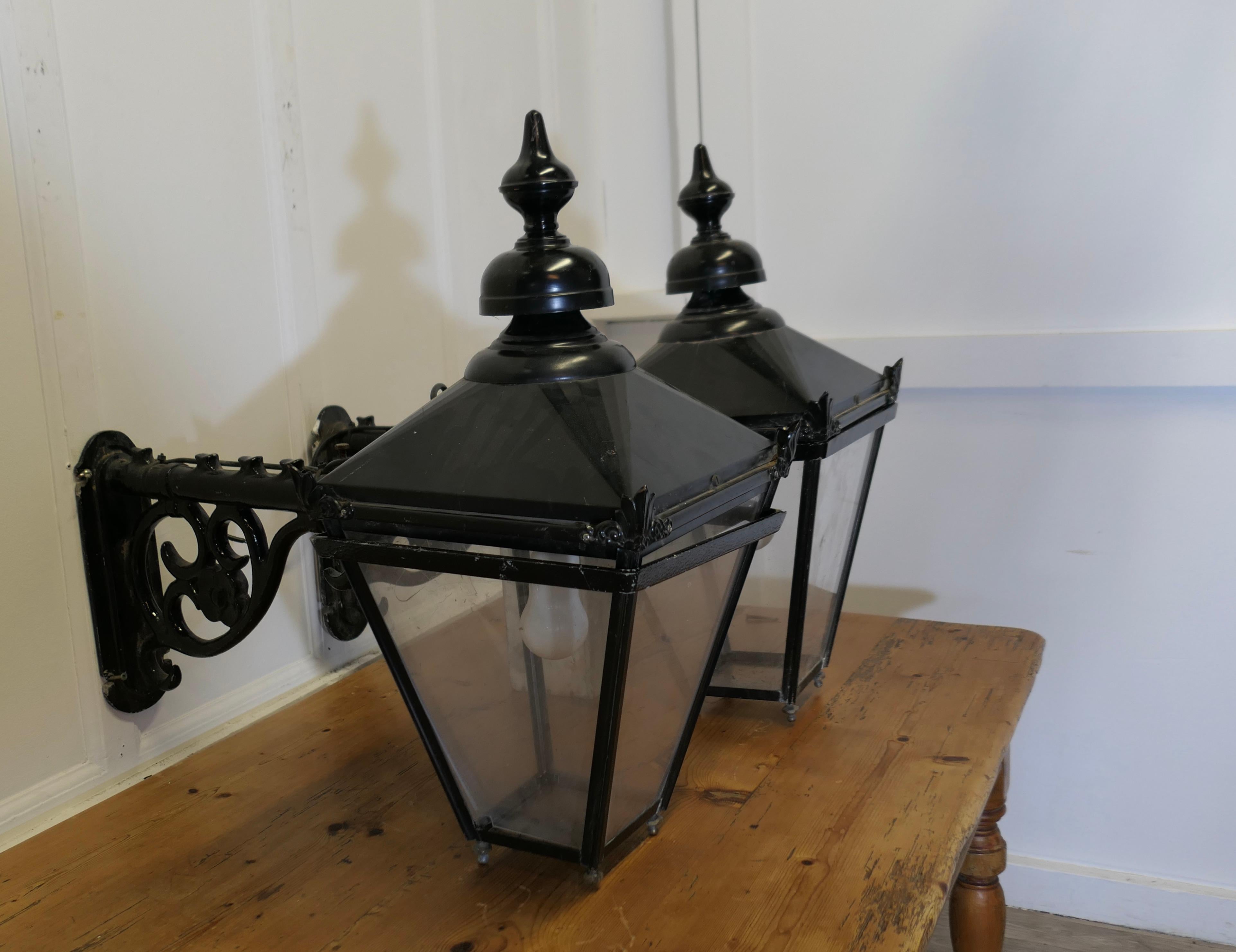 A Pair of Large Painted Copper Wall Hung Pub Lanterns

These are old pub lights, the Large Copper Wall Lanterns are made in copper which has been overpainted in black and they hang on a metal wall fitting bracket
A Handsome pair, the lanterns have