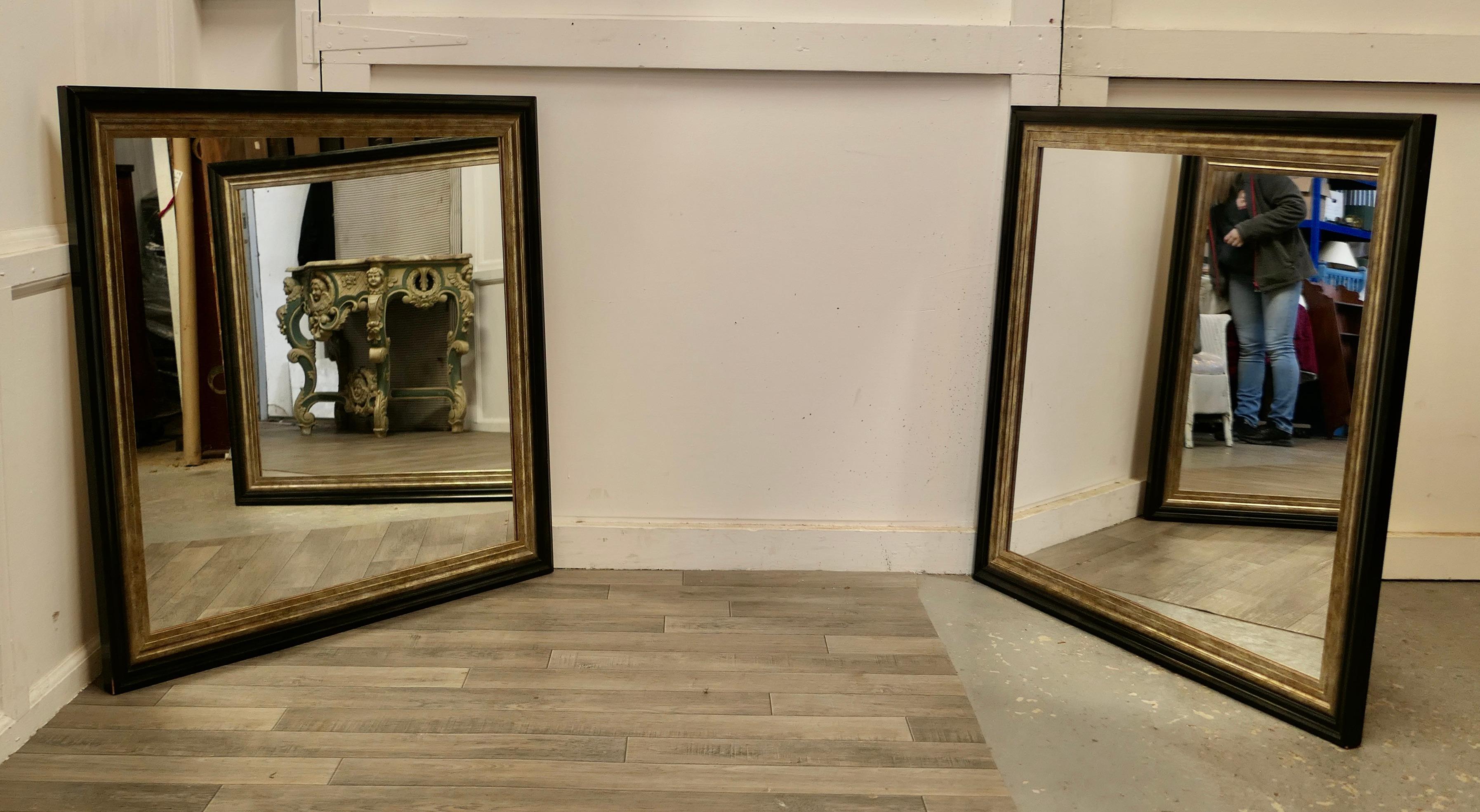 A pair of large rectangular wall mirrors

The mirrors have a simple moulded 4” wide black frame with gold inset borders, these show a little wear to the finish 
The looking glasses have been replaced as have the backs
A good mirror will always