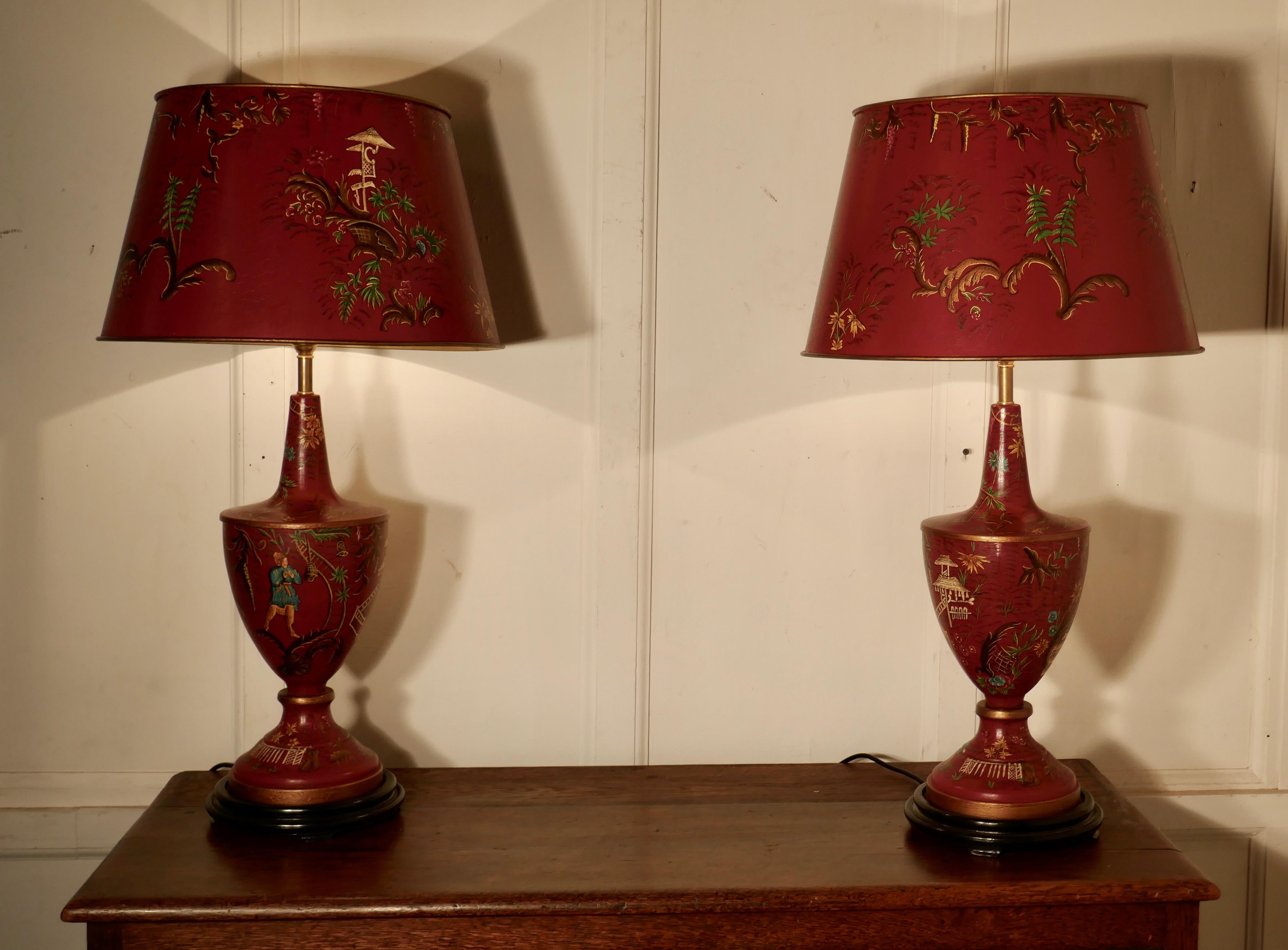 A pair of large red chinoiserie toleware table lamps

The large stunning lamps have matching shades, both lamps and shades have a crackle glaze finish and are hand painted with both color and gold detail
The lamps are fully wired and in very good
