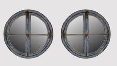 A pair of large round mirrored windows with wooden frames France, 18th century.