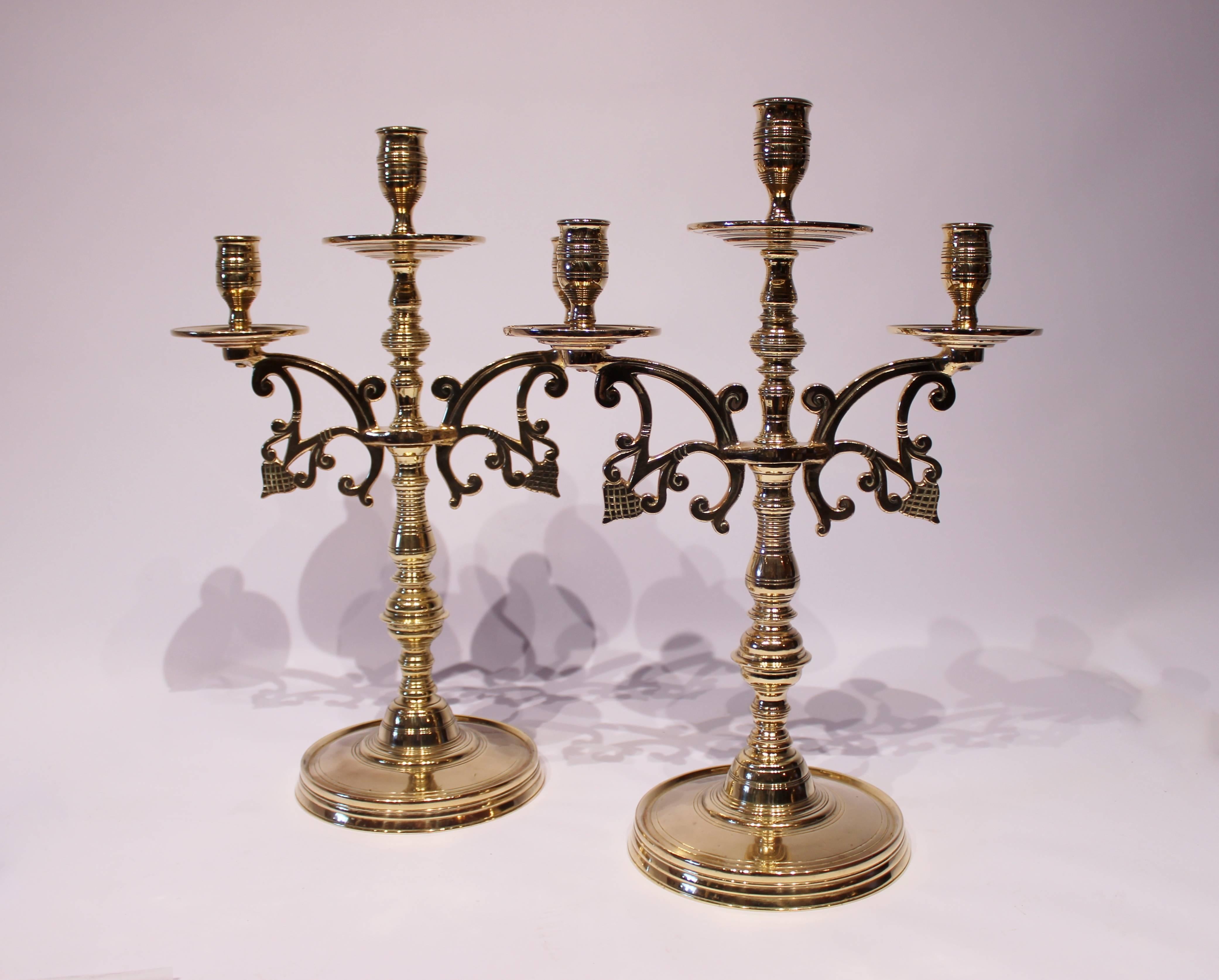 A pair of large three-armed brass candlesticks, in great vintage condition from circa 1890s.
