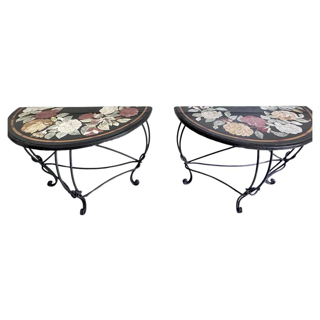A remarkable pair of late 19th century Ashford marble Pietra Dura console tables, each set upon a contemporary iron base that subtly enhances the visual impact of the marble tops. The surfaces are crafted from Ashford Black Marble, a dark limestone