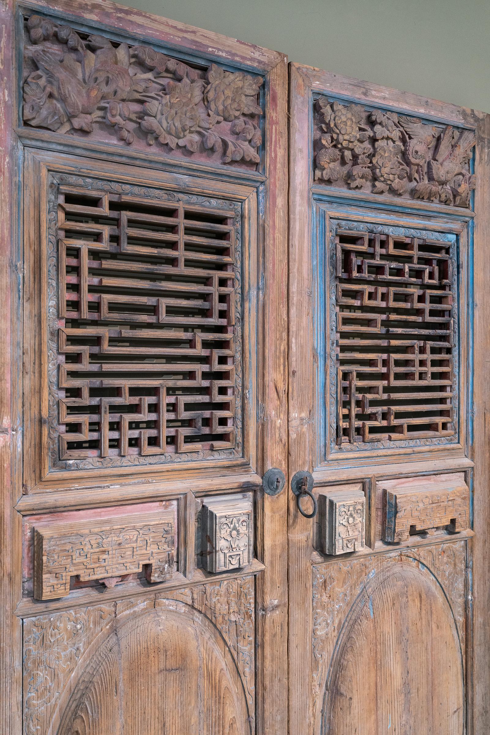 A pair of late 19th century door panels from Chaozhou province, China. The top panels are very striking, as the carvings of birds & flowers are very deep and lively, and the bottom sections have bulbous panels which are distinctive of Chaozhou-style