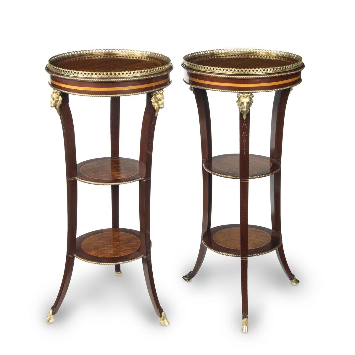 A pair of late 19th century French 3 tier satinwood side tables, each with a circular top with an ormolu gallery, all three tiers decorated with a boxwood diamond trellis on a satinwood ground, purpleheart banding, raised on outswept feet with