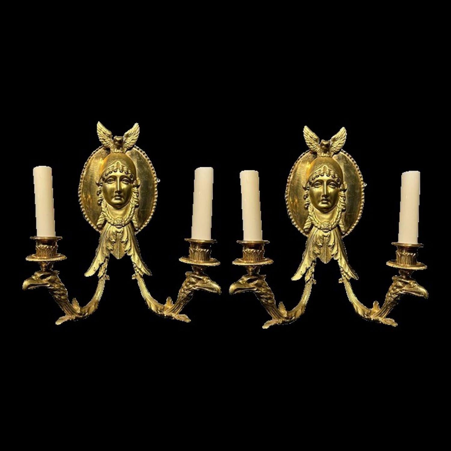 A pair of circa late 19th century French Empire sconces with eagle's heads and woman's faces. Original finish and patina, *8 available