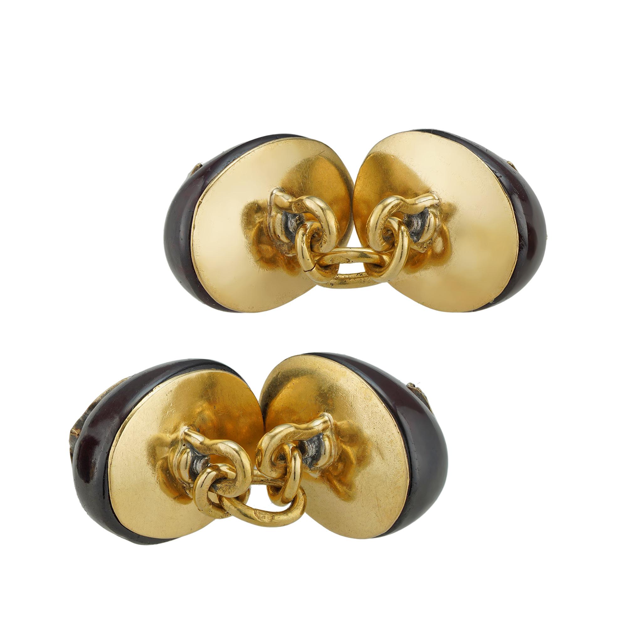 A pair of late 19th century garnet and diamond cufflinks, the oval cabochon garnets with applied old-cut and rose-cut diamond set stars to the centre, all to a yellow gold mount with link fittings, bearing French gold marks for 18ct gold, circa