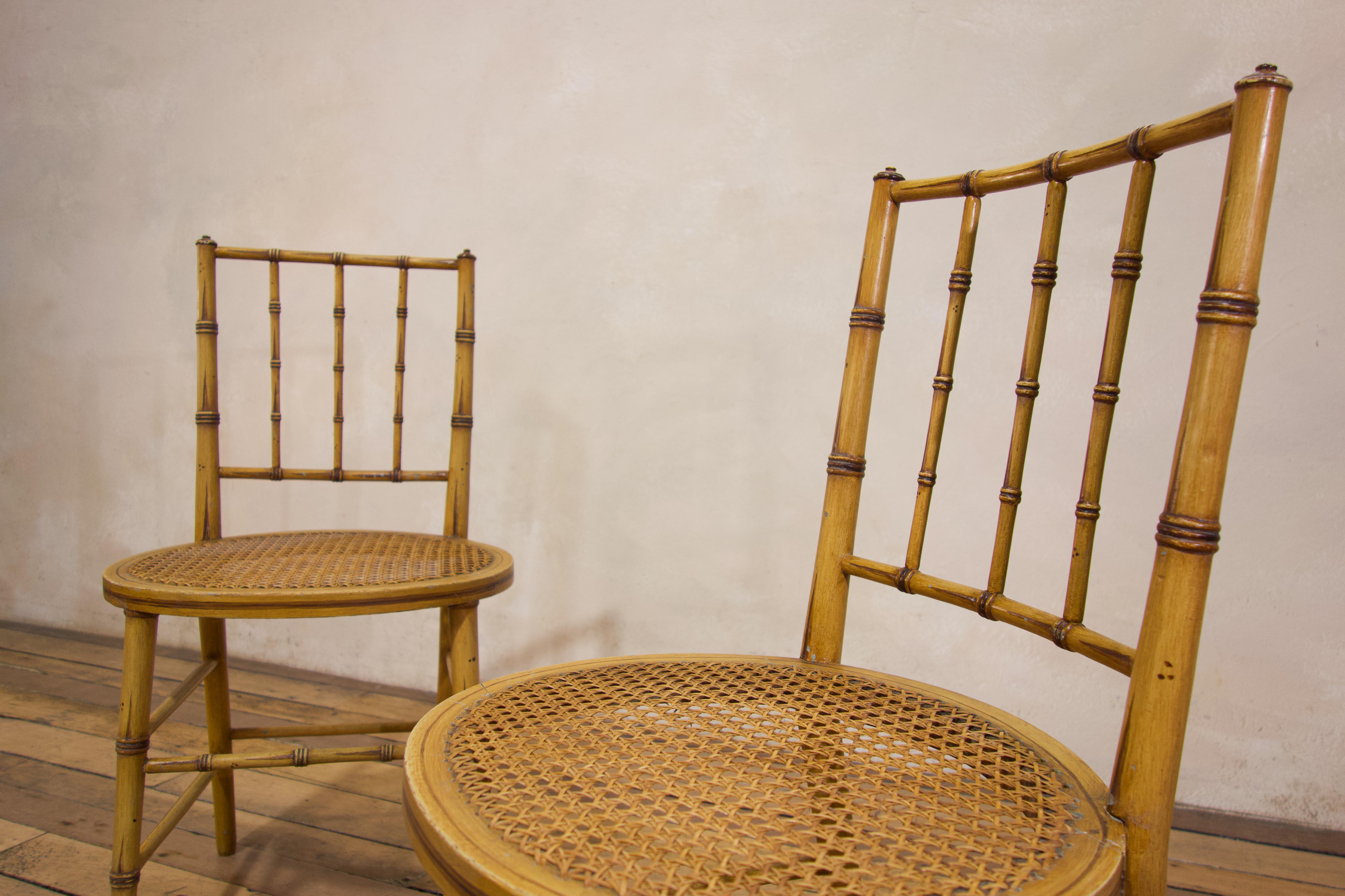 A pair of late 19th century faux bamboo side chairs. Displaying oval caned seats, raised on faux bamboo turned legs united by stretchers. 
Featuring extremely well-executed paintwork, dating from the mid 20th century. 
 
Measures: Height - 80cm