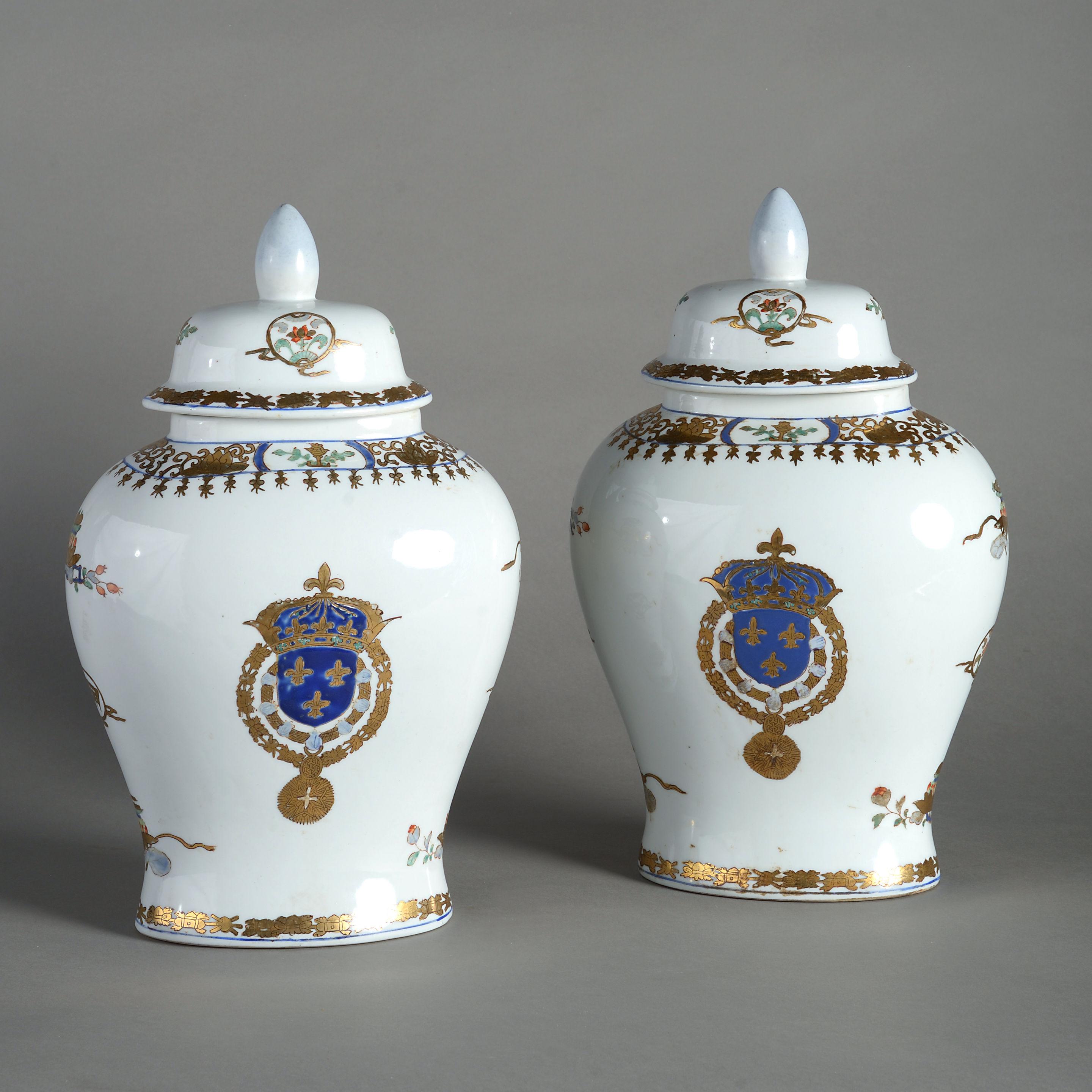 A pair of late nineteenth century Samson porcelain vases and covers, the bodies decorated with gilded red green and blue glazes on a white ground and depicting the royal arms of France.