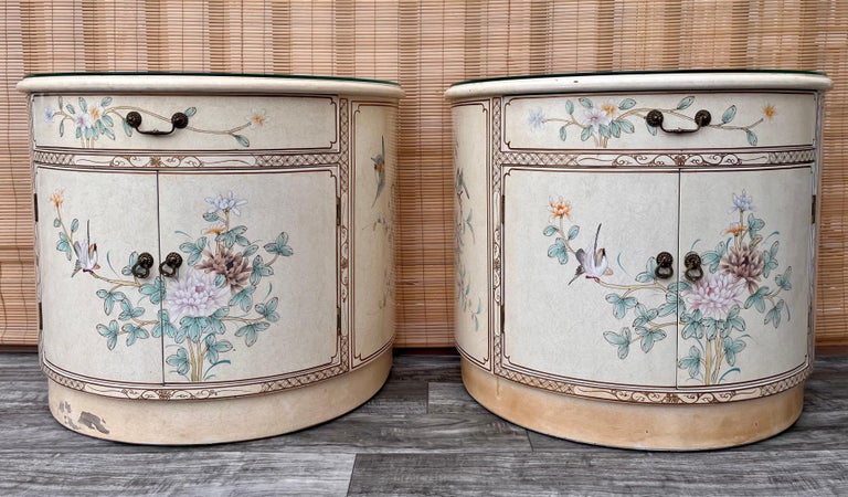 A pair of late 20th century Chinoiserie Lacquer nightstands Circa 1990s.
Feature rounded fronts with an ornate light yellow lacquer finish with an intricate chinoiserie decoration and removable glass tops. Offering plenty of storage room with top