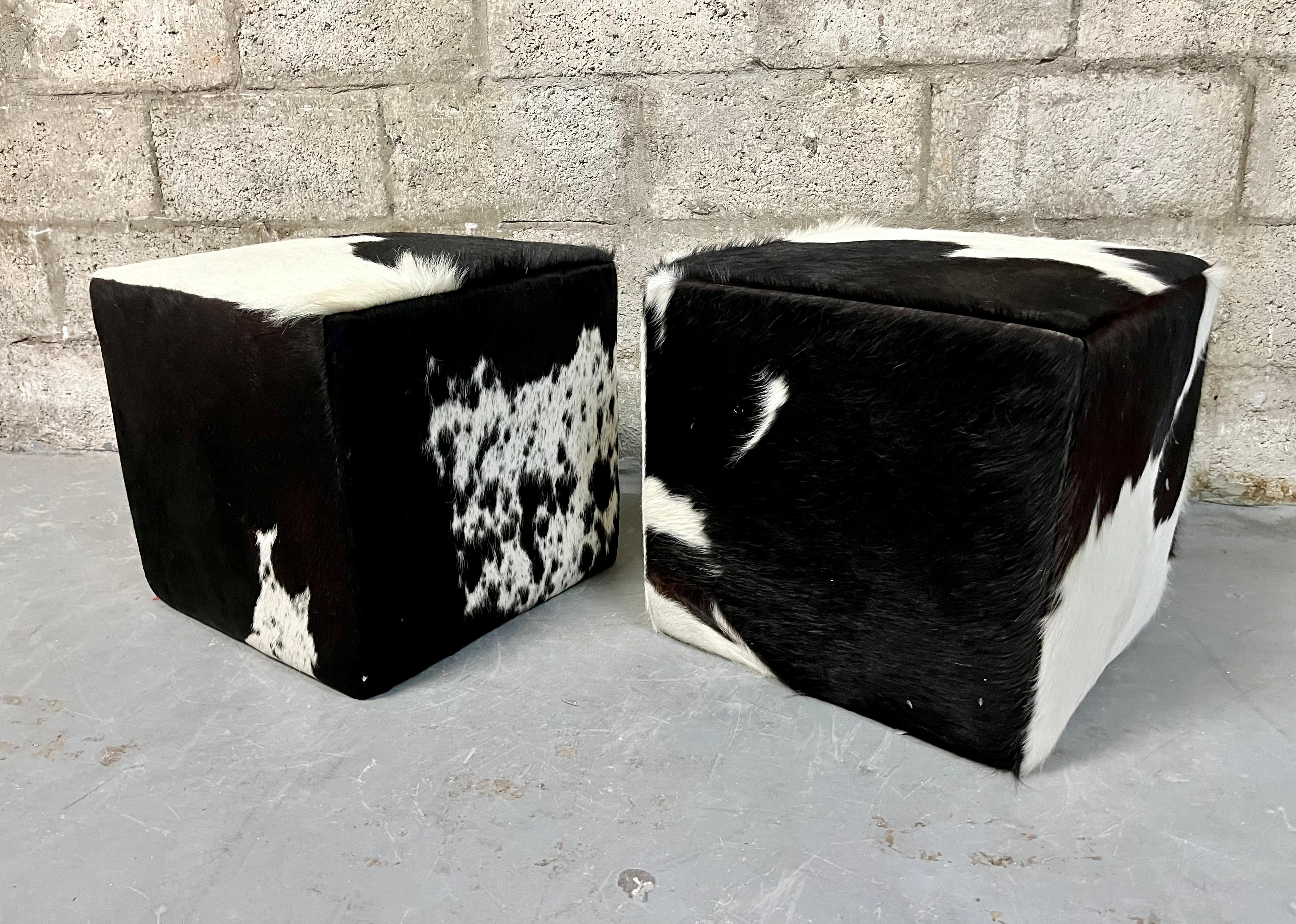 A Pair of Late 20th Century Cow Hide Ottomans/ Footstools.
Cube shaped ottomans upholstered with a premium quality real cowhide 
In excellent original condition with minor sings of wear and age.  Please see close up pictures for more details.