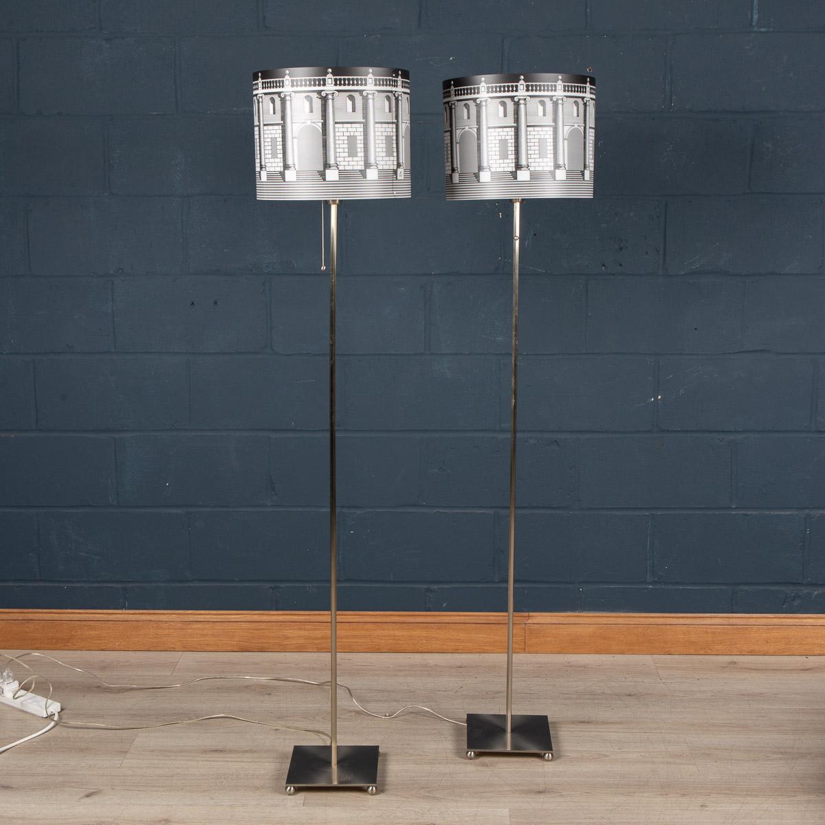 A beautiful pair of floor lamps by Piero Fornasetti. This particular model retailed by Antonangeli in the 1990s, now discontinued and appreciating in value. More importantly it gives any room a very chic twist on lighting with its brushed steel