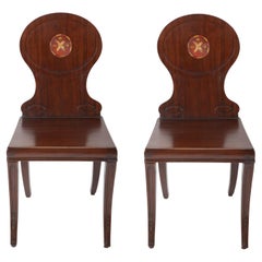 A Pair of Late Georgian Mahogany and Polychrome Hall Chairs