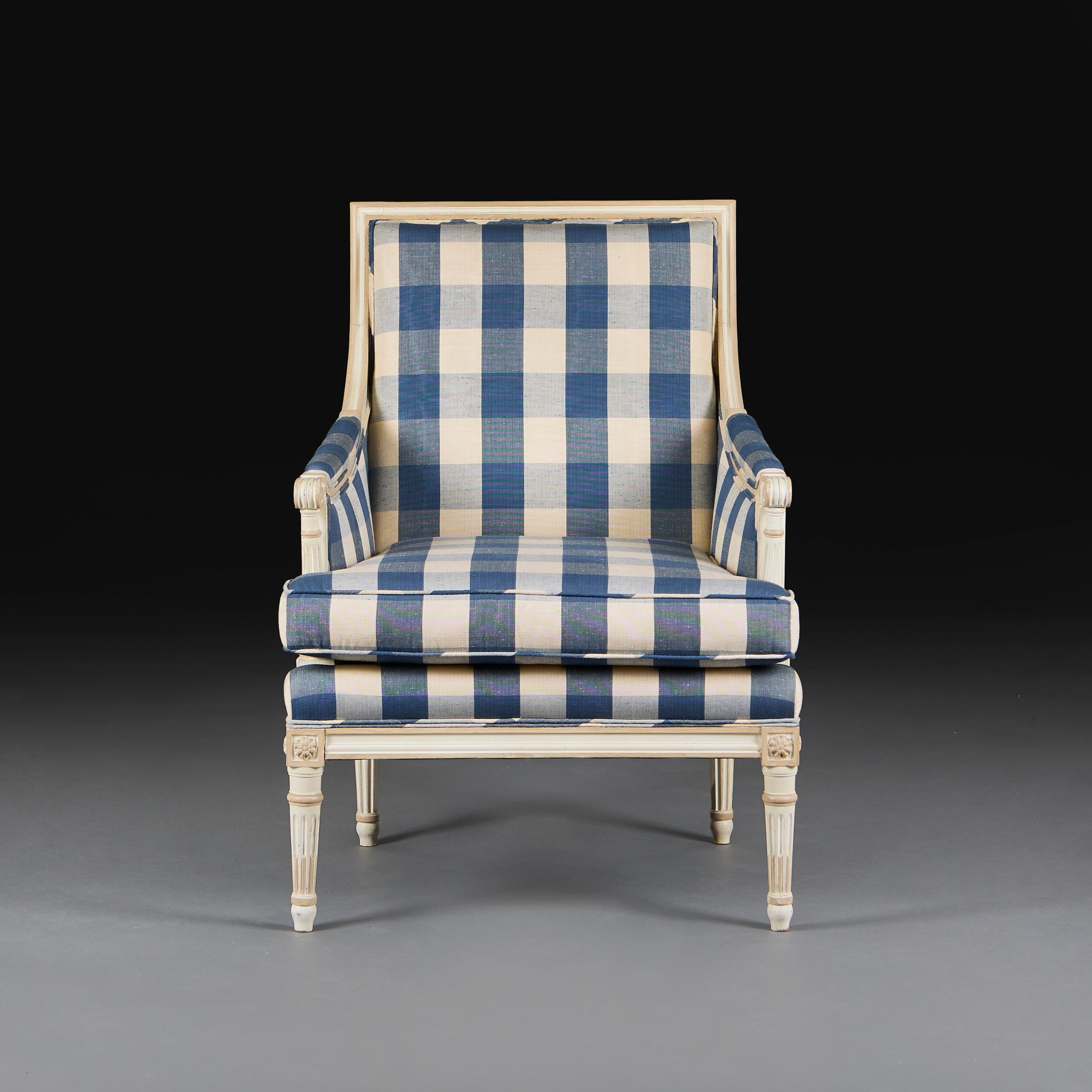 A pair of late nineteenth century neoclassical French fauteuils now upholstered in Colefax and Fowler Blue Eaton check.