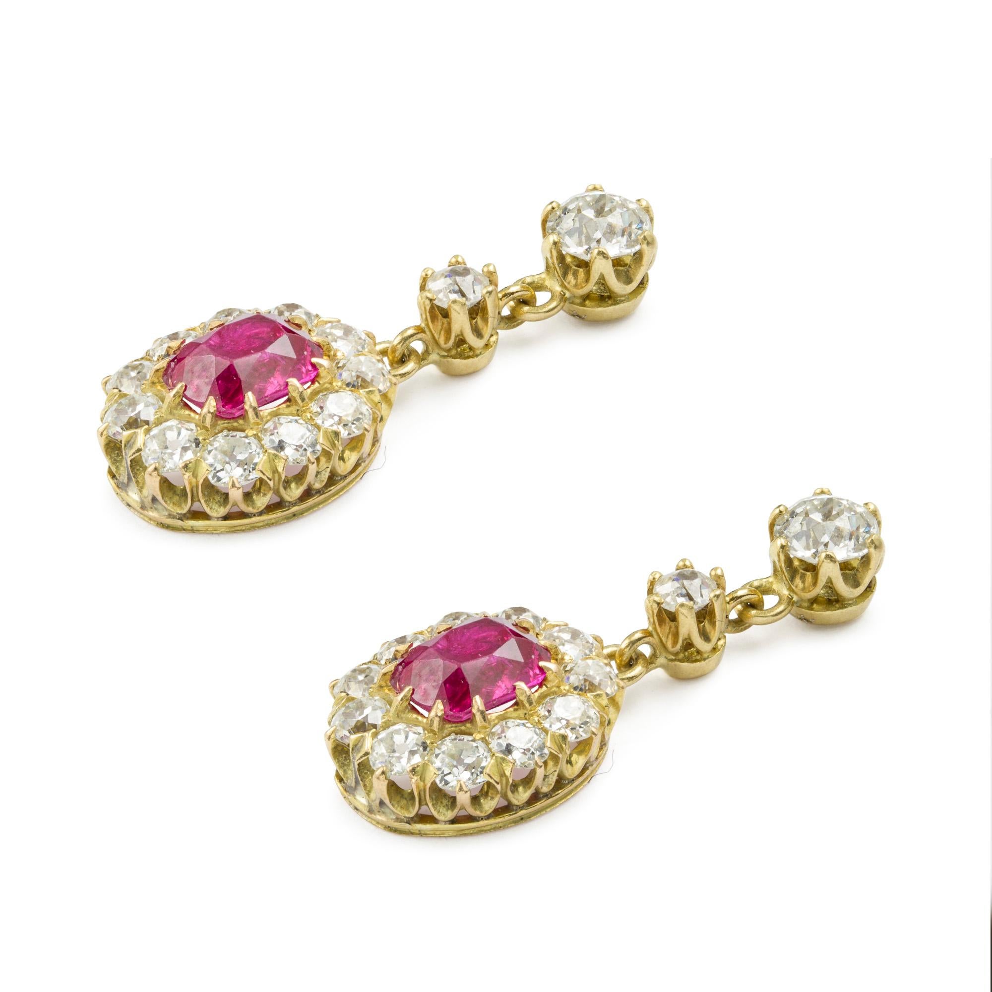 A pair of late-Victorian Burmese ruby and diamond cluster drop earrings, the cushion-cut rubies accompanied by GCS Report stating to be of Burmese origin, weighing 1.44 carats, each set within a boarder of old-cut diamonds, suspended from two