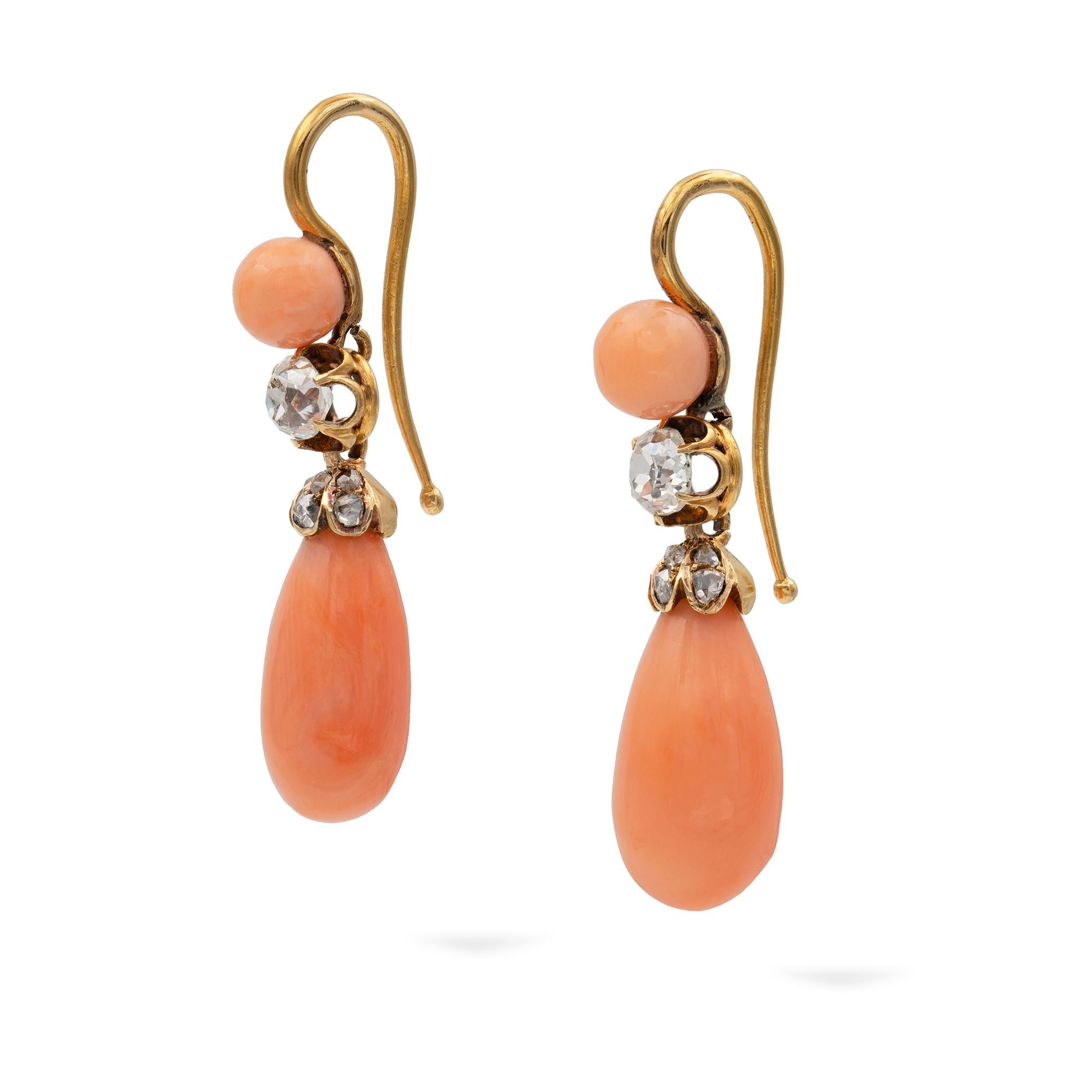 A pair of late Victorian coral and diamond drop earrings, the top of each set with a round coral ball approximately 5mm size suspending an old mine-cut diamond estimating to weigh totally 0.45 carats, set in six claw open collet, leading to a