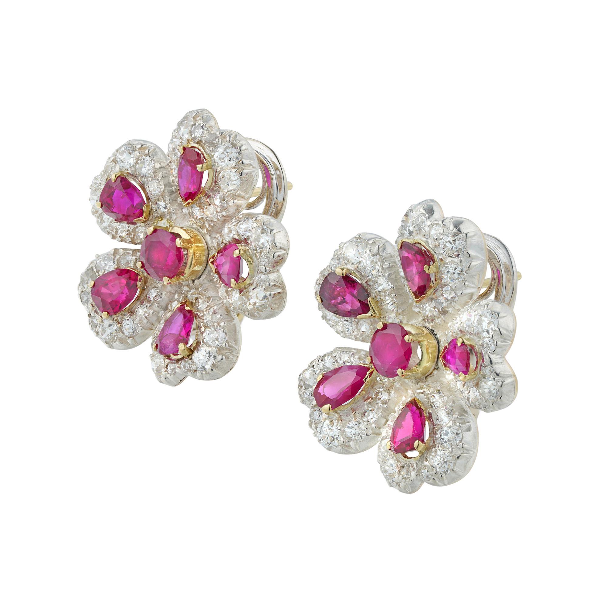 A pair of late Victorian ruby and diamond earrings, each in the form of a flower, centrally-set with a round ruby, surrounded by five petals, each set with a pear-shaped ruby surrounded by old European-cut diamonds, the rubies estimated to weigh 4.2