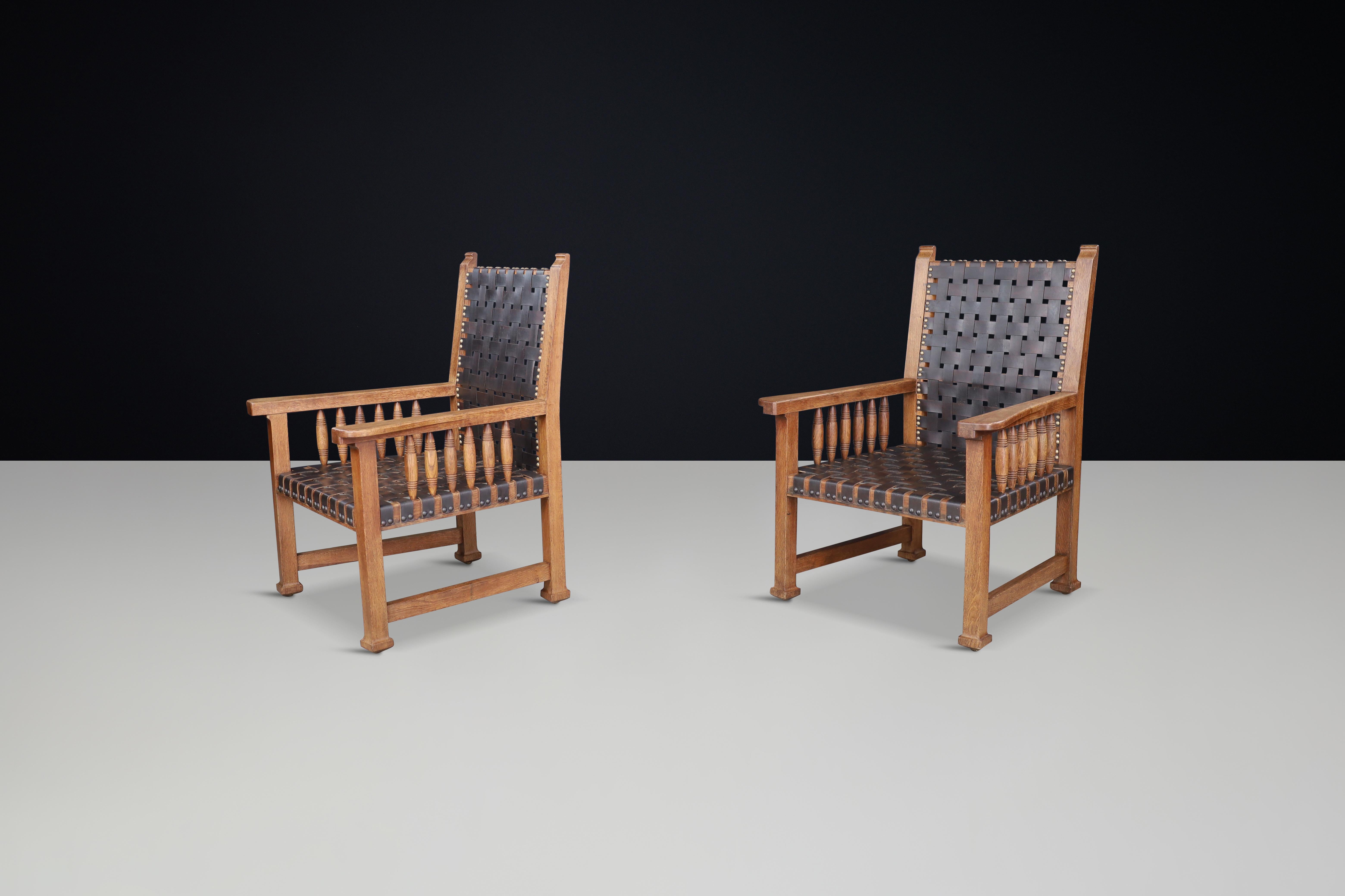 A pair of leather and oak armchairs from France, 1950s. For Sale 1