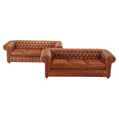 A pair of leather Chesterfield style sofas. Made to order.