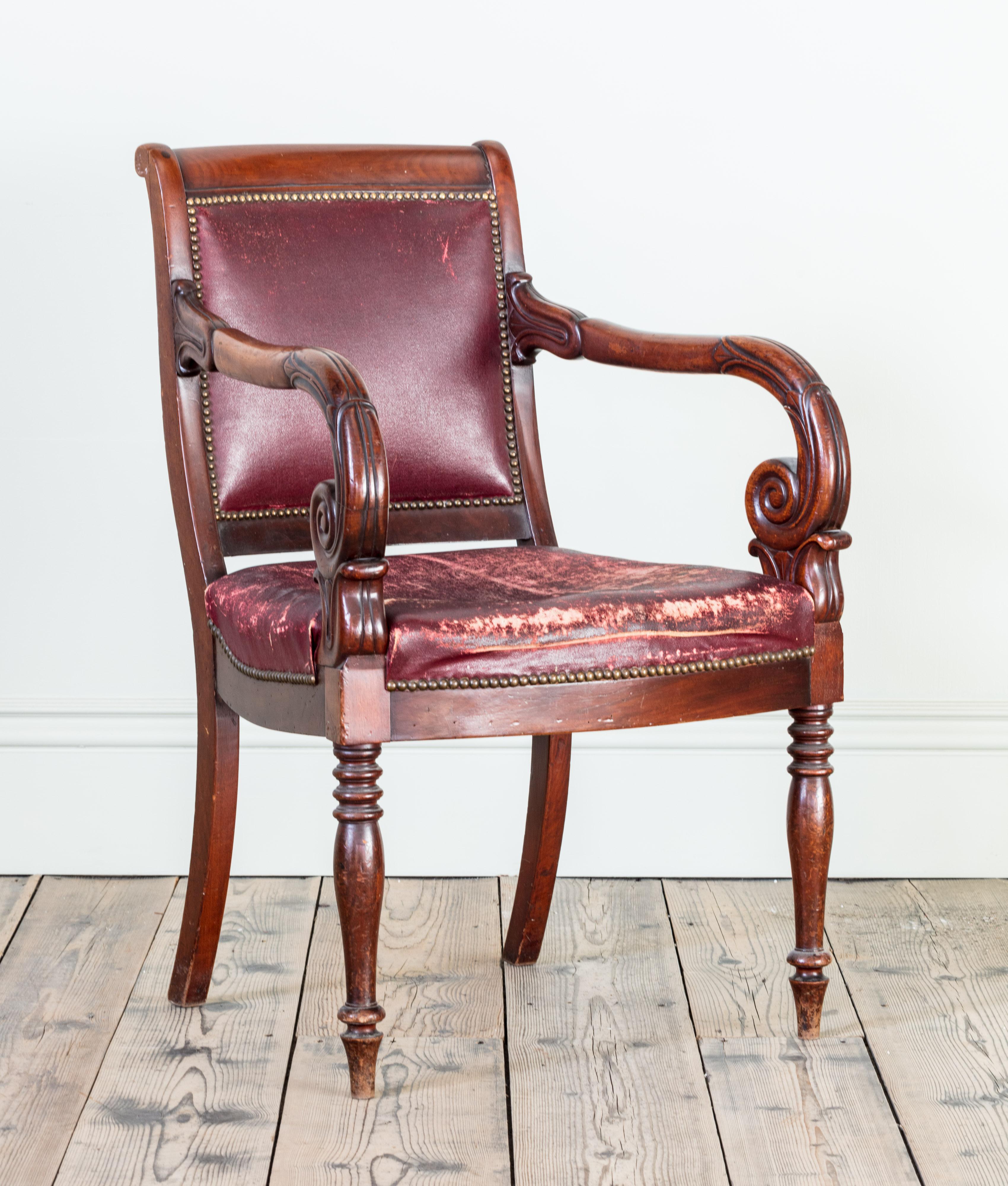 With faded and worn red Moroccan leather upholstery.