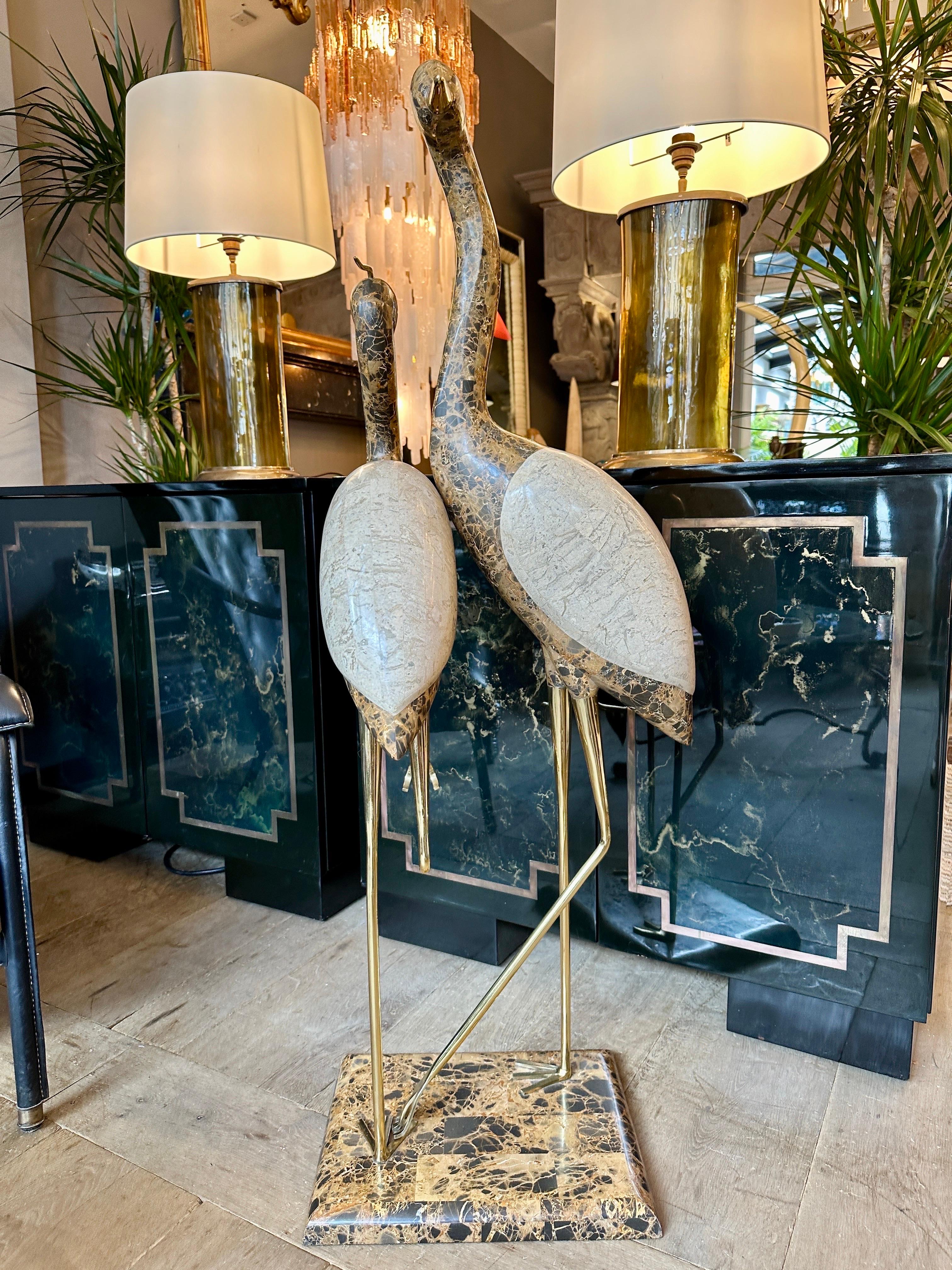 A pair of life size Cranes  Sculpture in Emperador marble and Brass by Maitland Smith USA. The method of tessellating the marble to a shape in very small fine pieces producing these very realistic Cranes with brass legs and bills. Both stood on a
