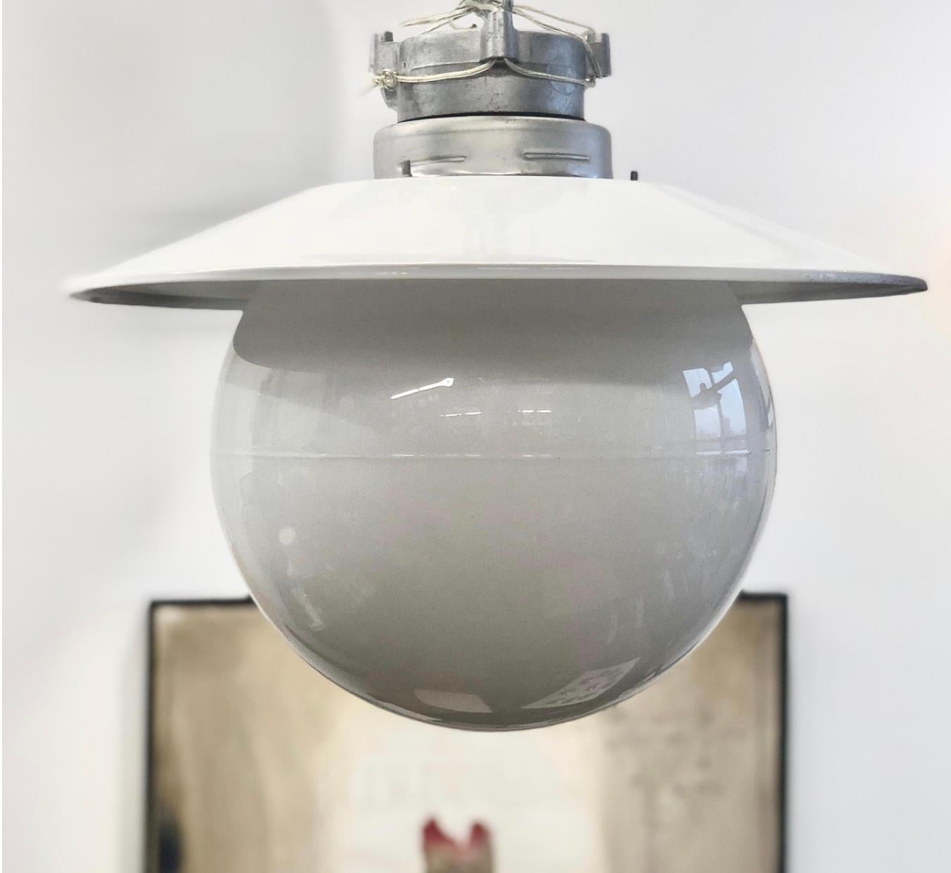 A pair of flush mount outdoor light designed by Paavo Tynell for Idman Oy, Model H10-100. Finland, circa 1950th. Large glass bawl with metal mount. Can be modified for mount on hanging rod. Marked by manufacturer. Glass shade diameter 12