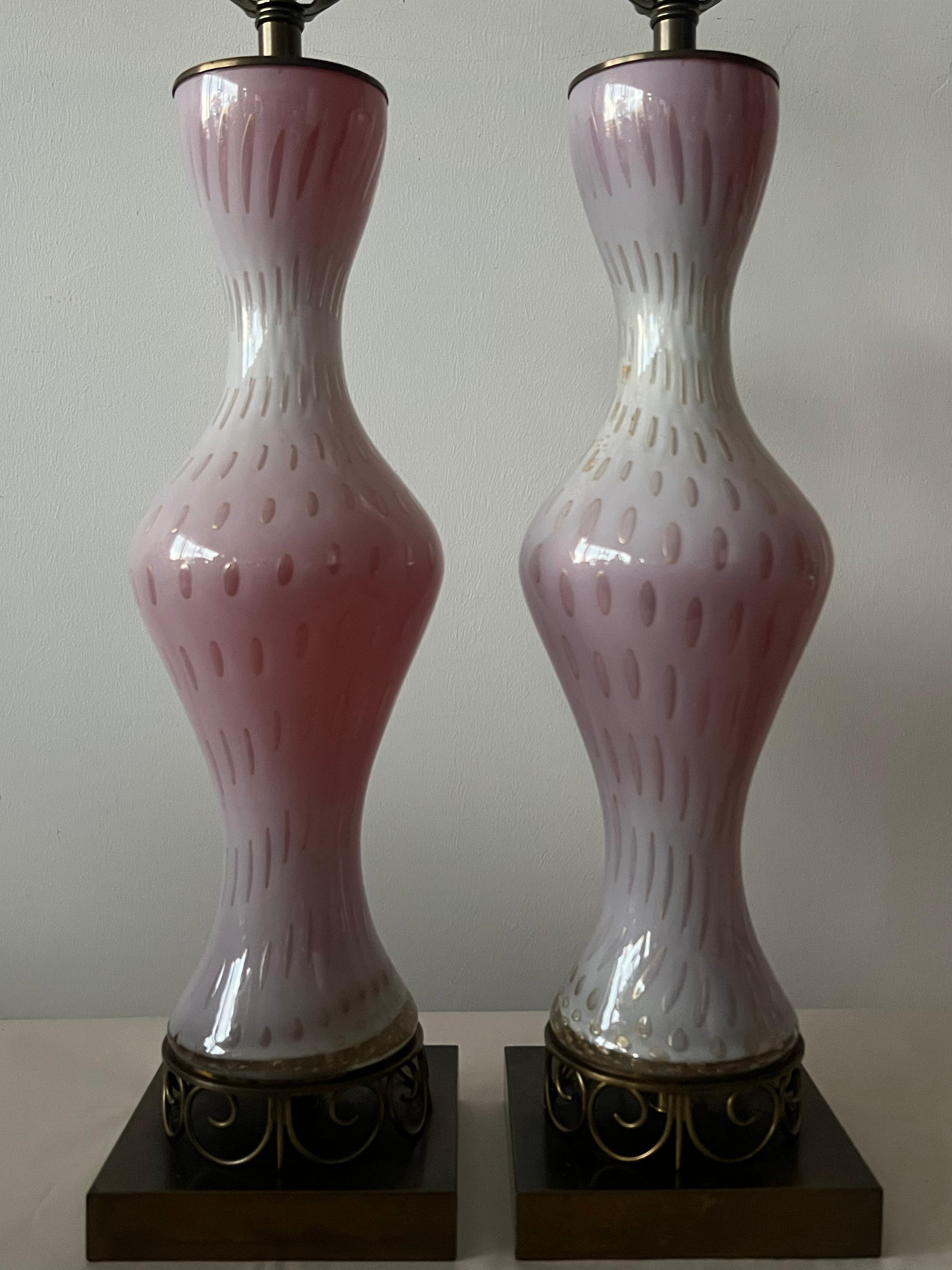 A pair of unusual hourglass lamps from Murano, Italy ca' 1950's. Mounted on unusual brass bases. Glass is thick with gold flecks. 