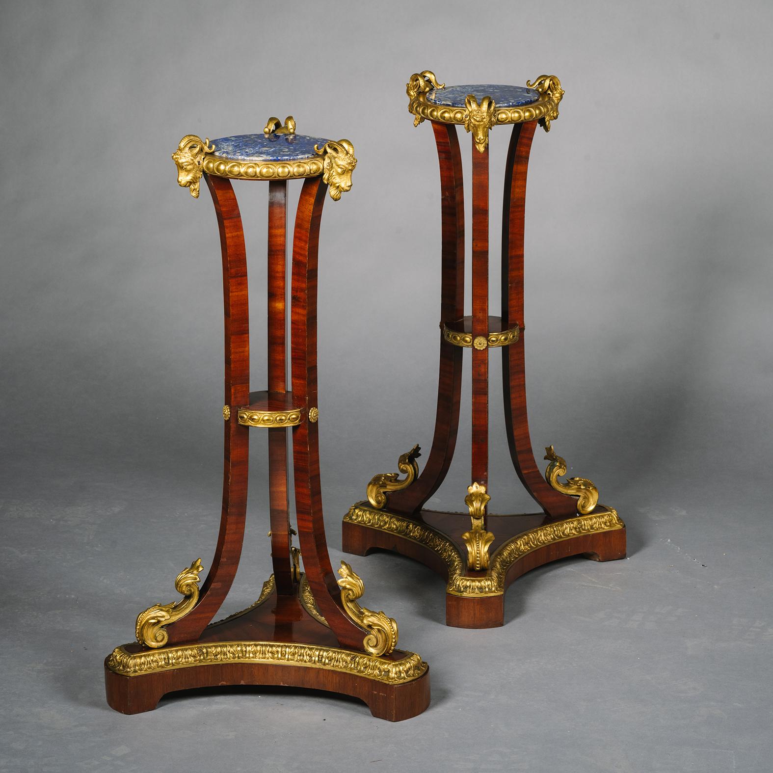 A Pair of Fine and Unusual Louis Philippe Period Gilt-Bronze, Mahogany and Lapis Lazuli Guéridons or Jardinière Stands.

Each with circular Lapis Lazil top with guilloche cast frieze. Supported on three curved legs heads by rams’ masks and joined by