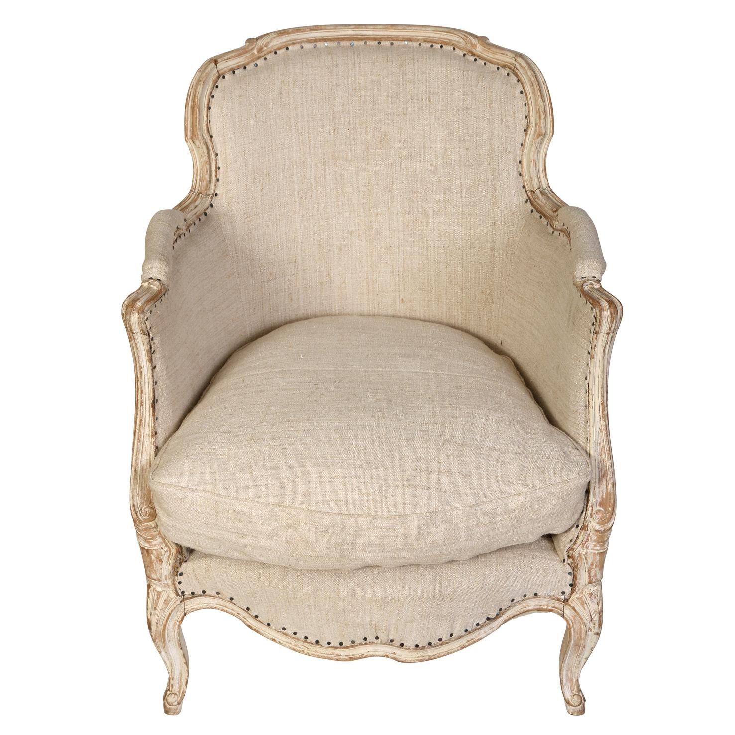 We love the scale of this pair of Louis XV style bergêres.  This duo has a grayish white finish upholstered in a natural linen with a tight back and loose seat cushion.  The lovely carving and cabriole legs are characteristic of the Lous XV style,