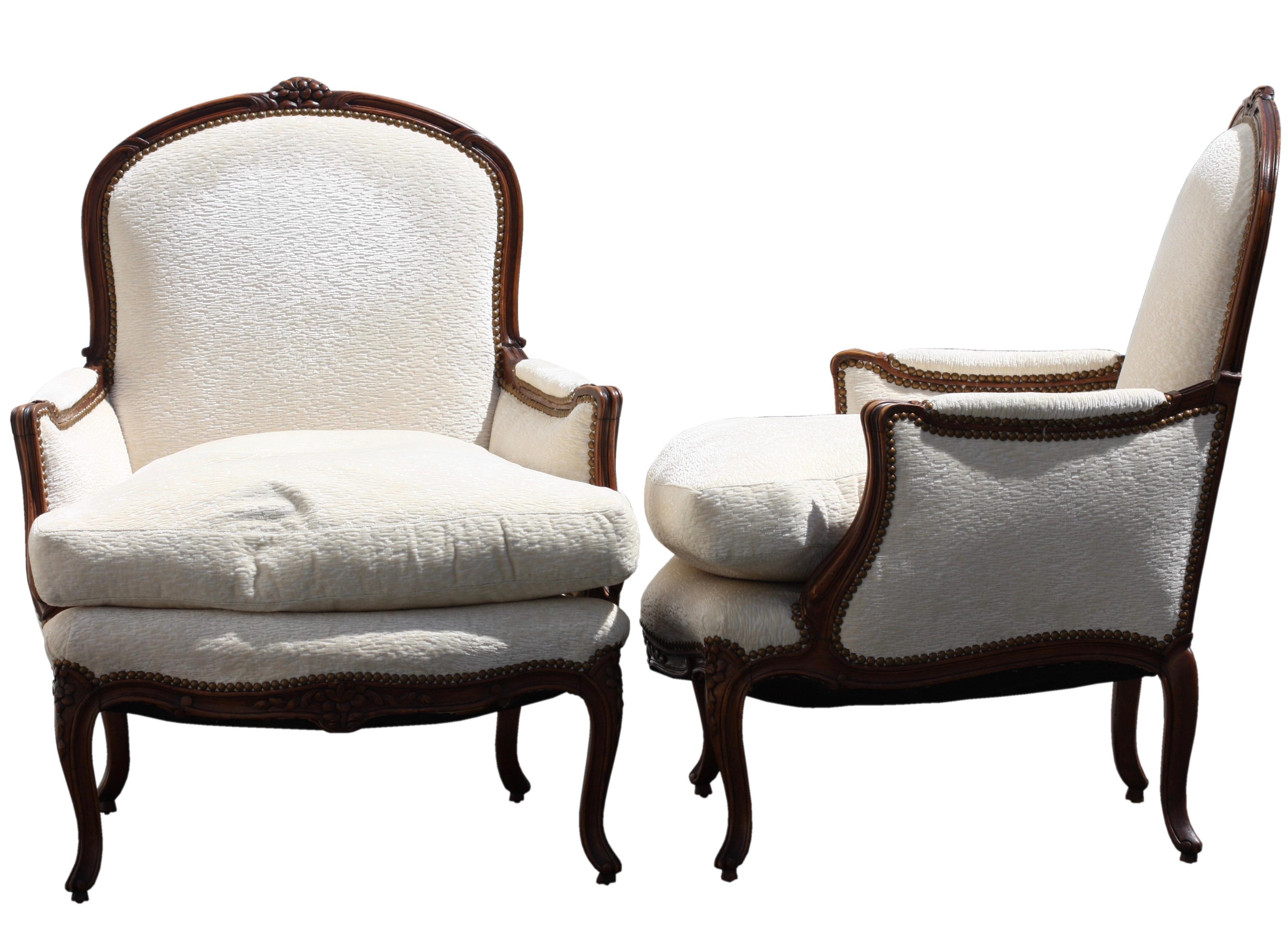 A pair of Louis XV style carved wood arm chairs 
mid-20th century,
Beechwood, fabric, 
Height 37.5 in. (95.25 cm.) 
Width 30 in. (76.2 cm.) 
Depth 30 in. (76.2 cm.).