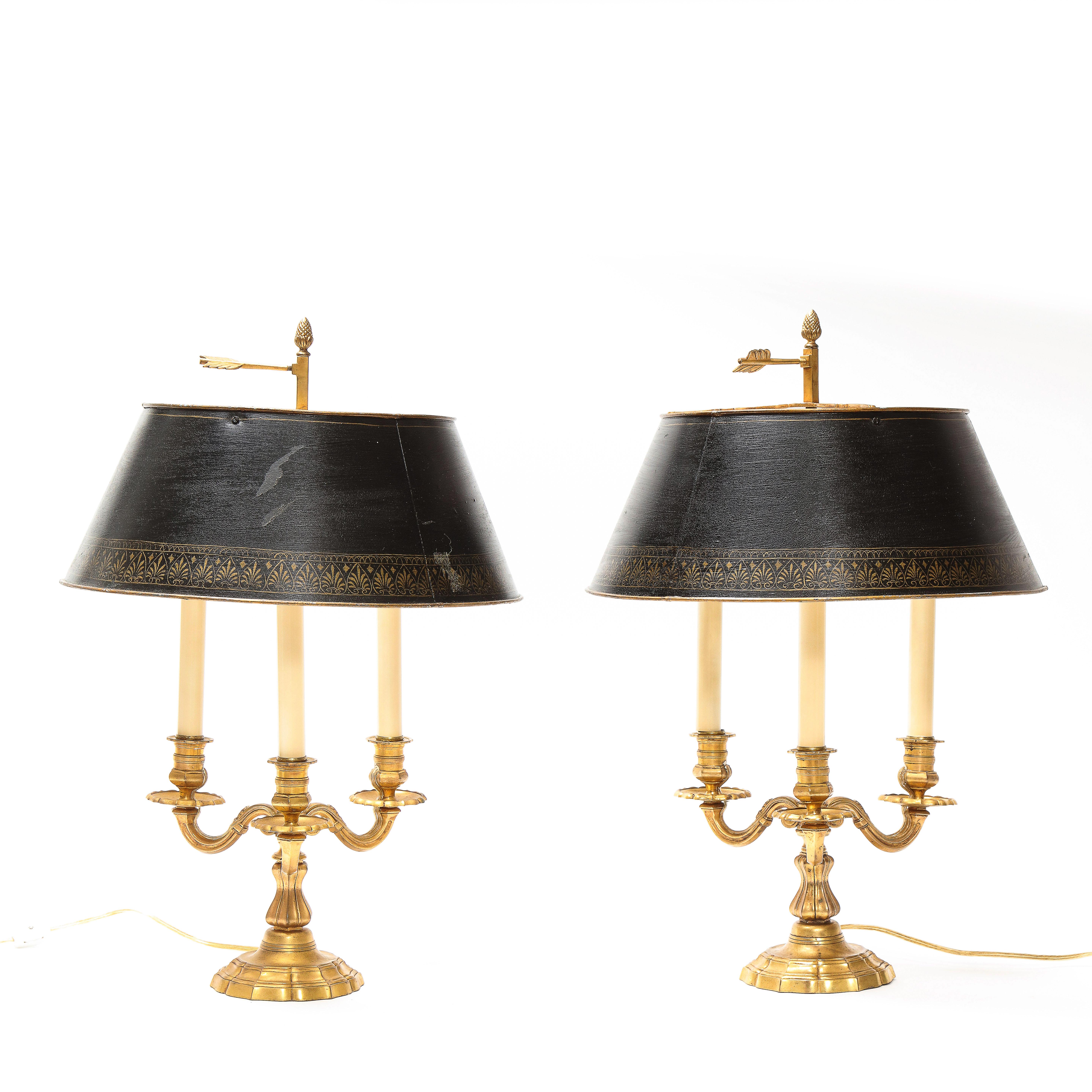 Each three arm candelabra; with painted black tin shades and gilt bronze finials, wired for electricity.

From the Collection of Mario Buatta, New York, NY.