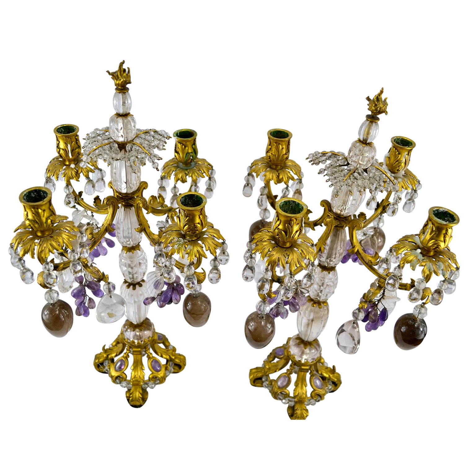 A finely chased pair of French Louis XV style gilded bronze, rock crystal, amethyst and smoky quartz four arm candelabra.