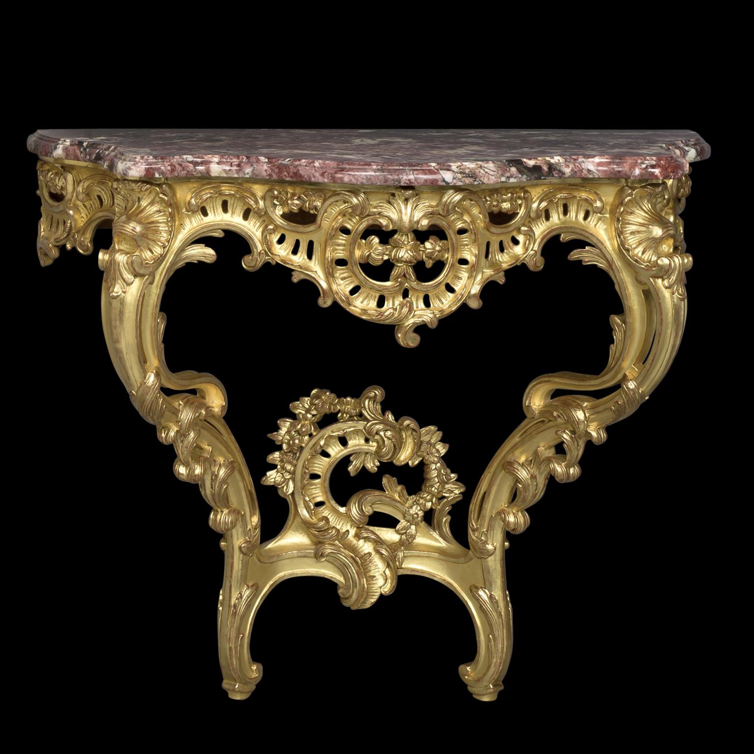 A Pair of Louis XV Style Giltwood Console d'Appliques.

Each console has a serpentine-shaped fleur de pêcher marble top over a pierced frieze carved with C-scrolls and acanthus, on scrolled supports and a conforming stretcher.  

French, Circa 1910.
