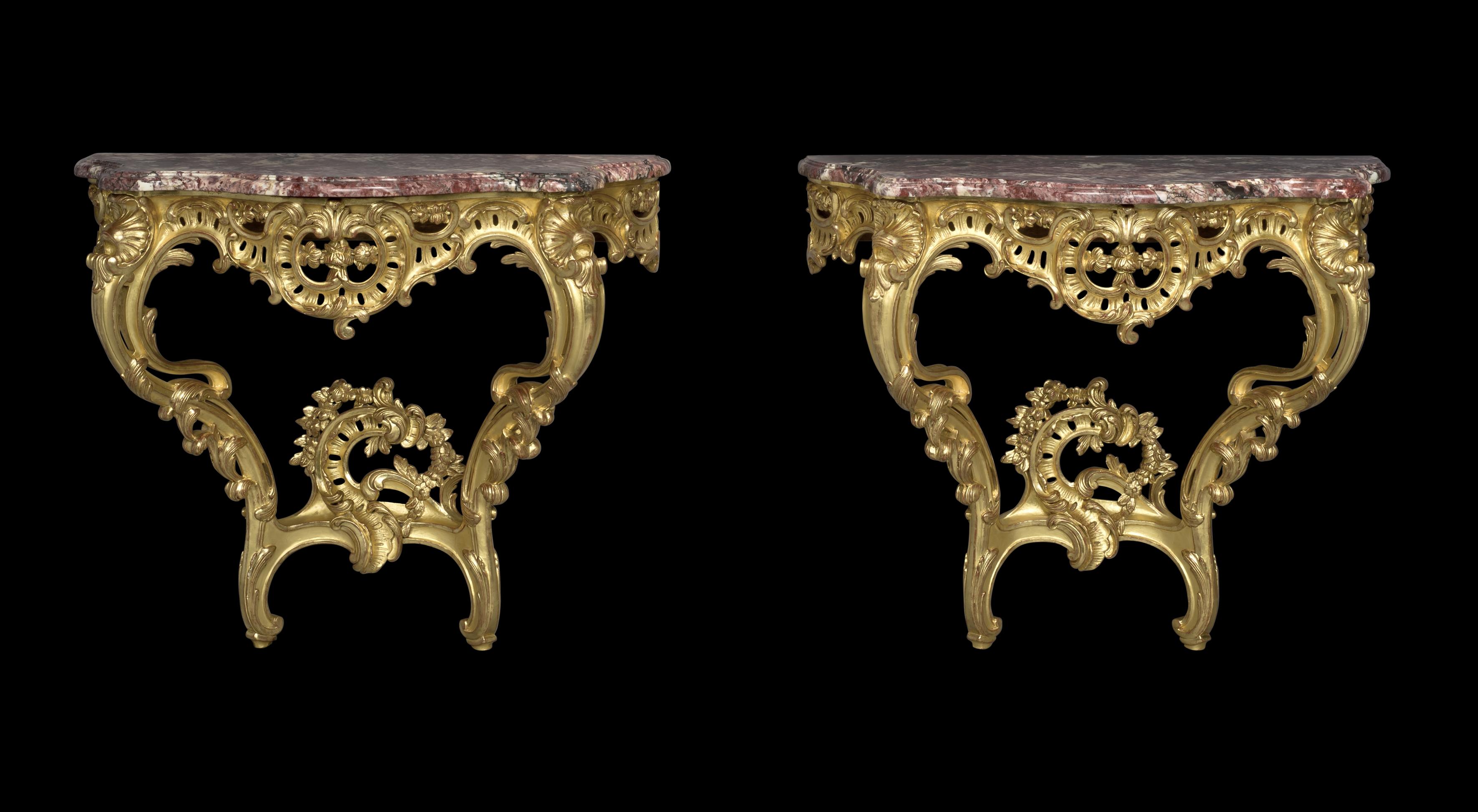 A pair of Louis XV style giltwood console d'Appliques.

French, circa 1910. 

Each console has a serpentine-shaped fleur de pêcher marble top over a pierced frieze carved with C-scrolls and acanthus, on scrolled supports and a conforming