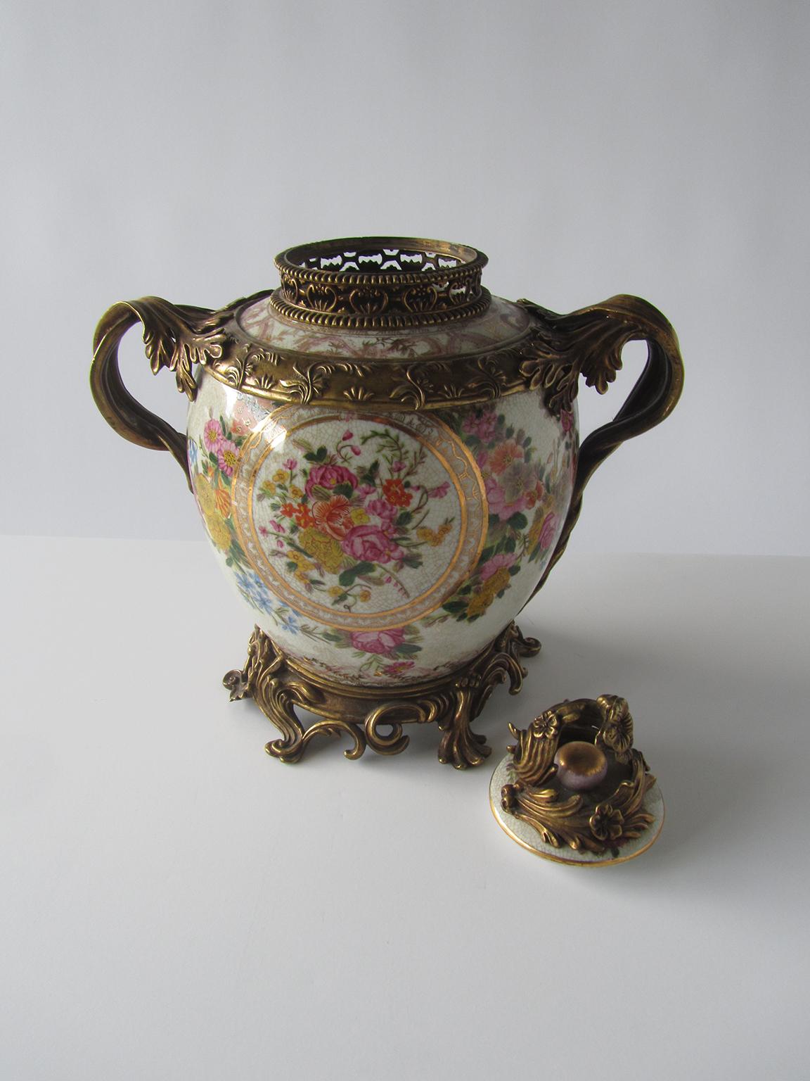 The Chinese porcelain covered urns with floral motif, with bronze dore' mounts.