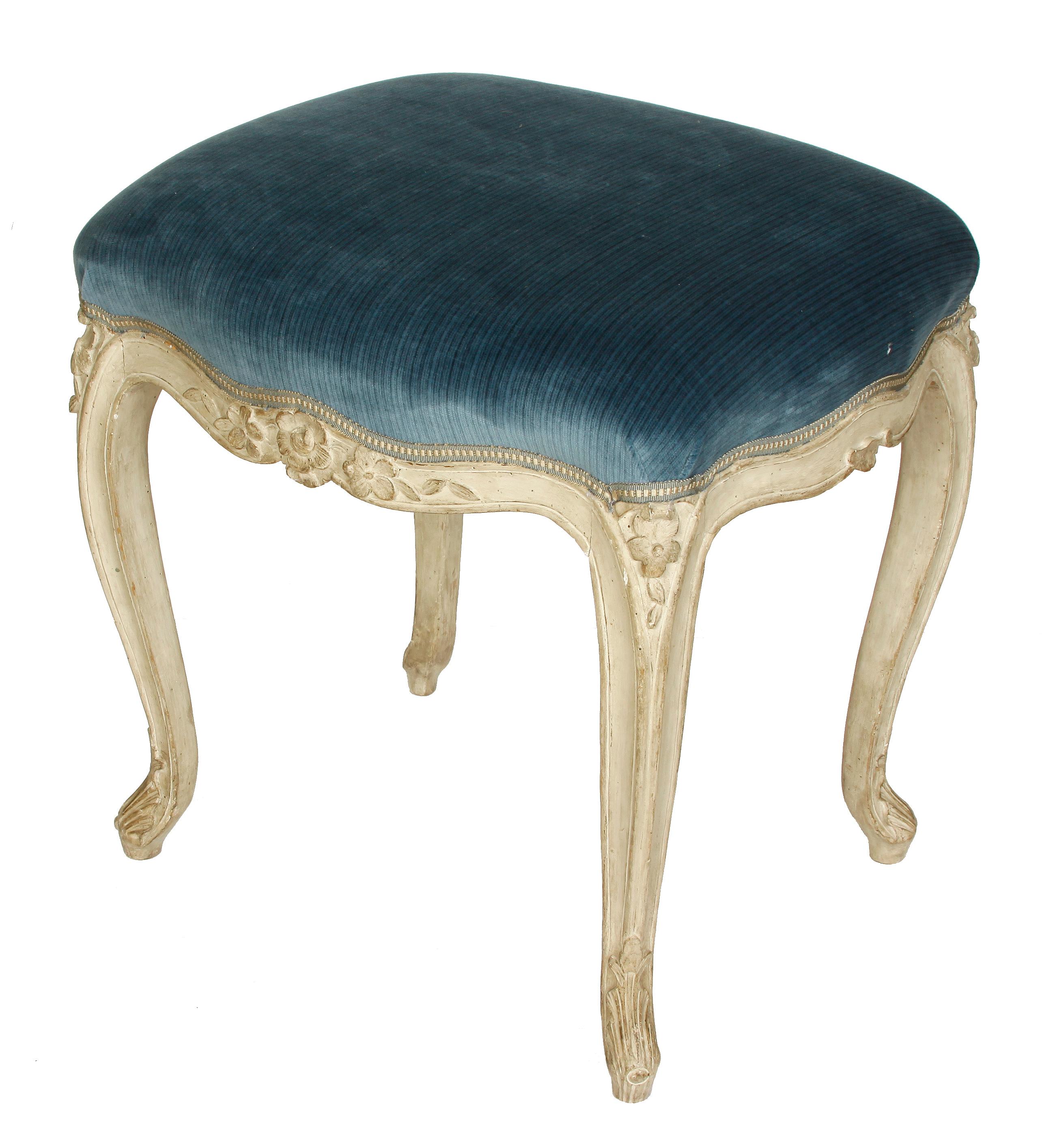 A pair of Louis XV style stools in blue strie velvet. Elegant stools with whitewashed base and cabriole legs with carved floral details.