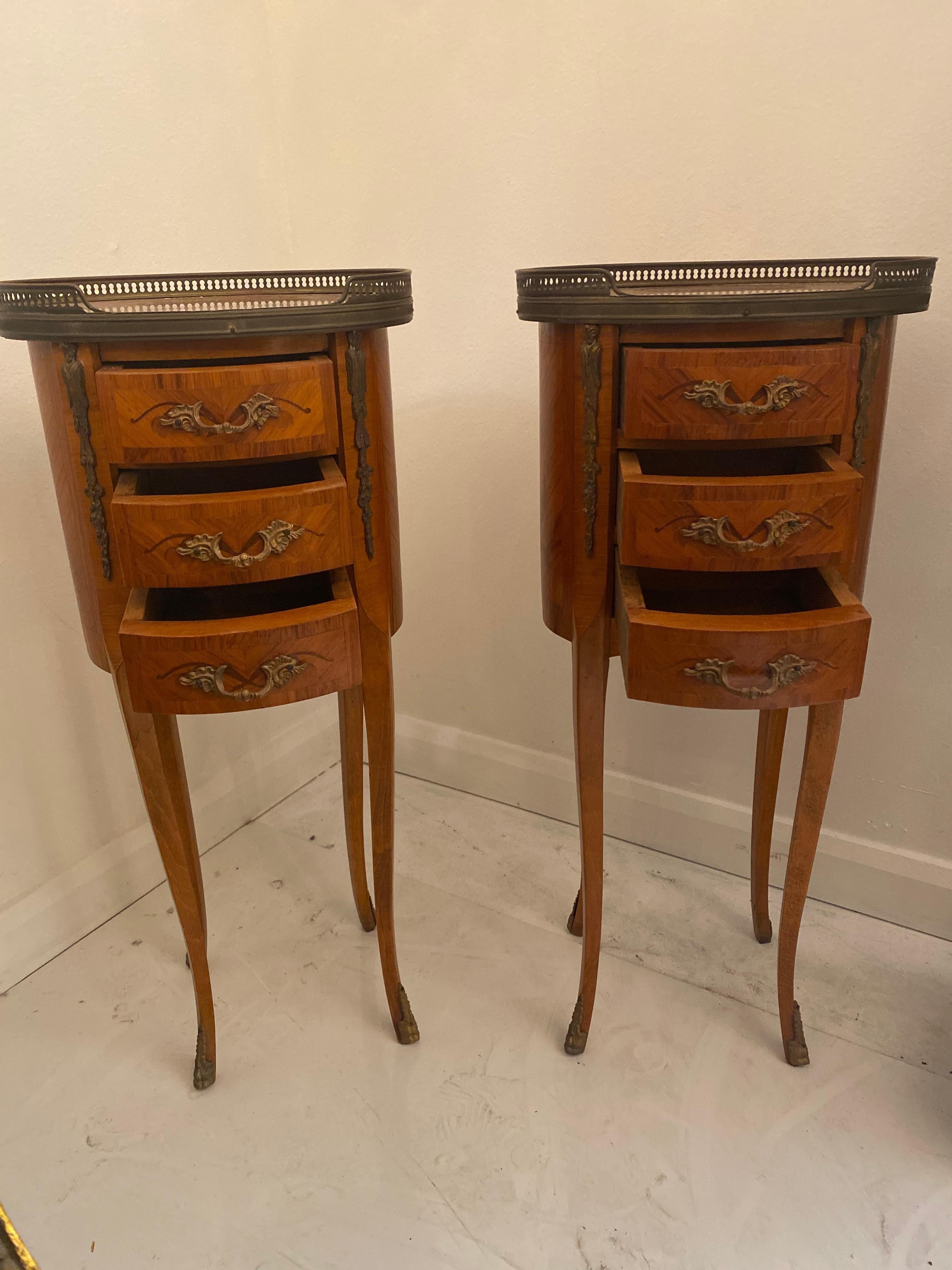 A pair of Louis XV/XVI transitional style gilt bronze mounted tulipwood, beechwood and marquetry oval occasional tables.