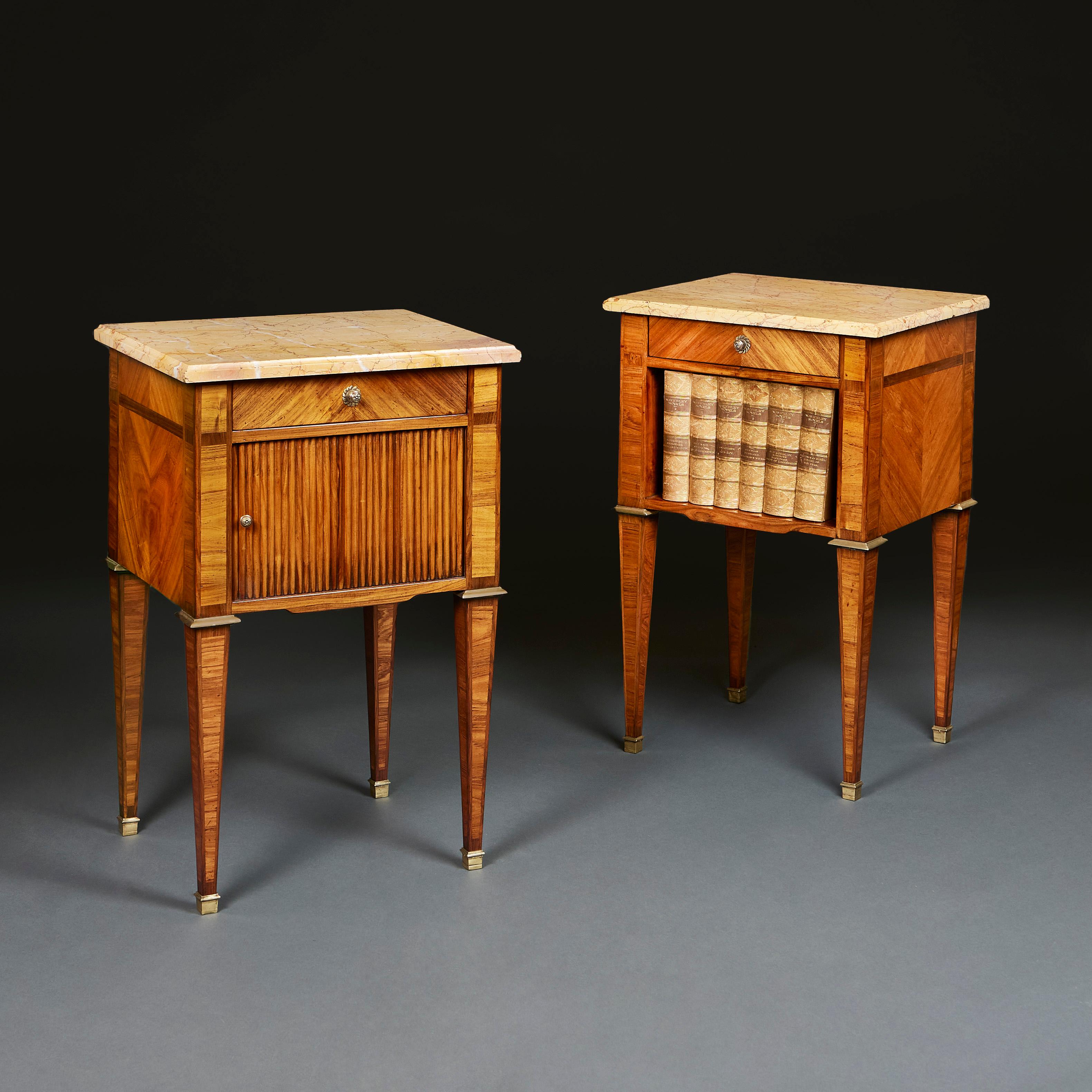 France, circa 1790

A pair of late eighteenth century kingwood bedside cabinets, one with sliding tambour front, the other with an open aperture. With breche d’alep beveled marble tops, all supported on tapering legs terminating in brass topie