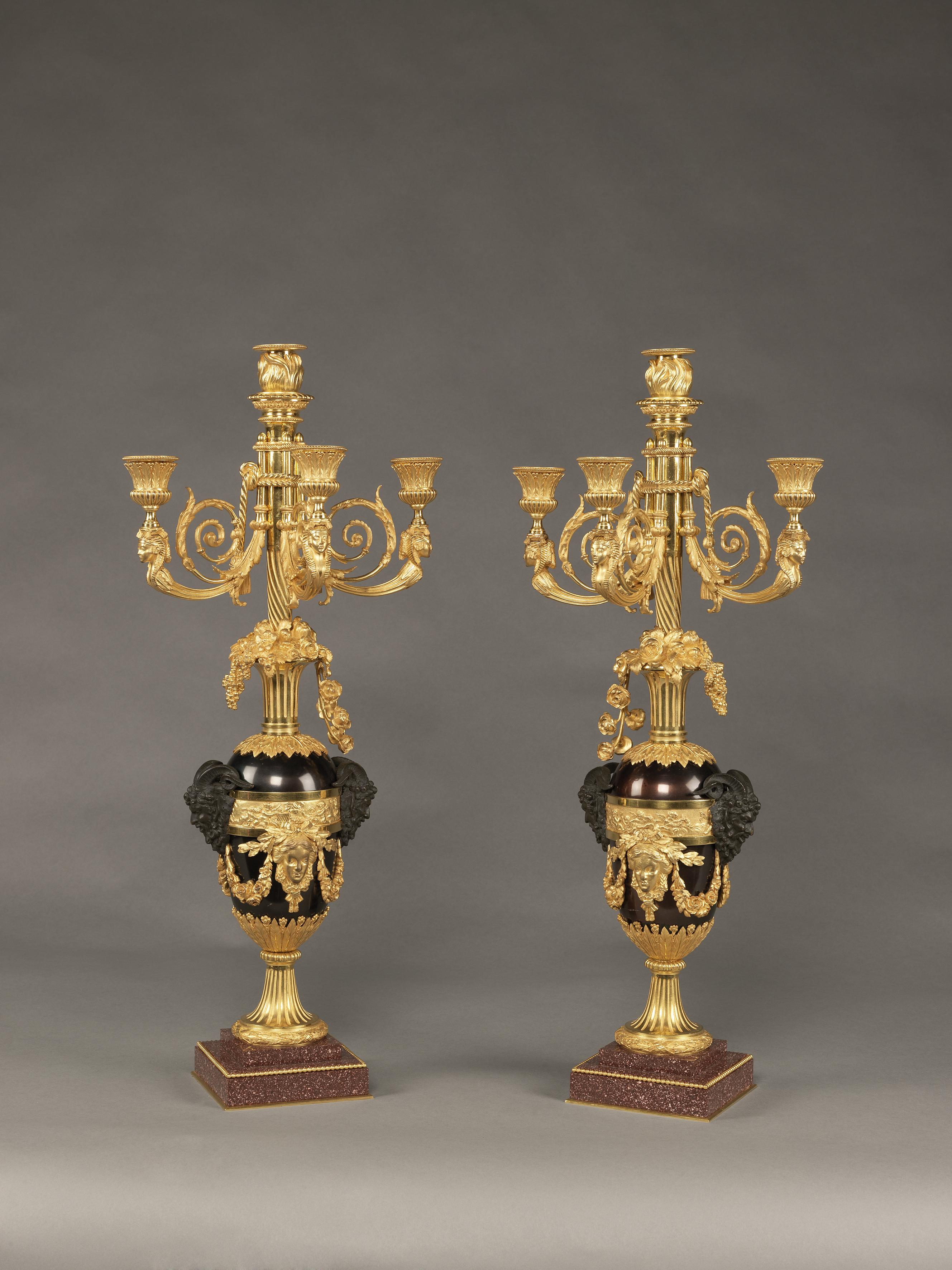 An important pair of Louis XVI style patinated and gilt-bronze four-light candelabra after the model by François Rémond, now in the Wallace collection, London.

French, circa 1830. 

Stamped to one bronze ring ‘RG’. 

Each candelabra has a