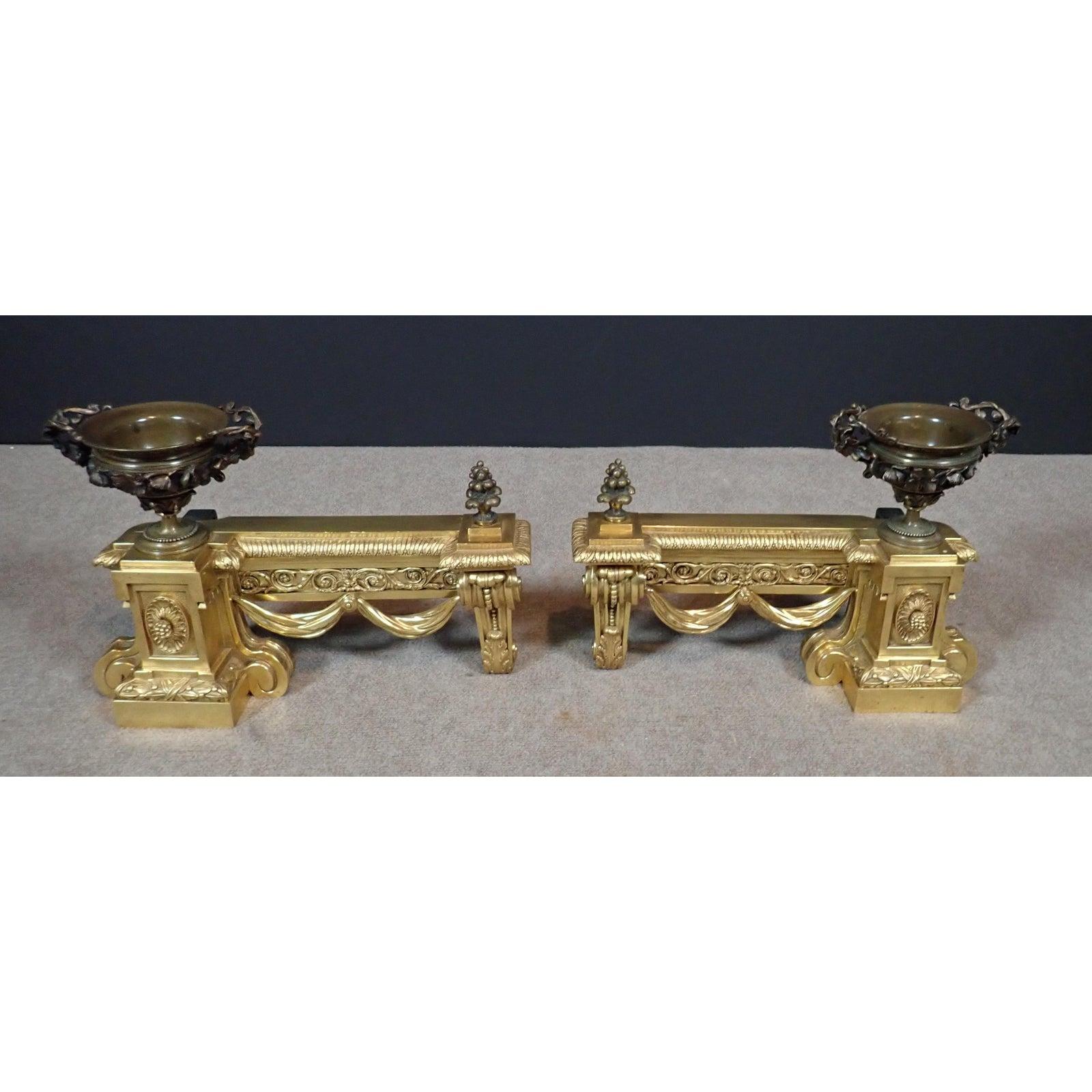 A pair of Louis XVI style gilt and patinated bronze Chenets/Andirons. Fine quality pair of 19th century Louis XVI Style French chenets. Doré and patinated bronze. Fine casting. Foundry markings on back.