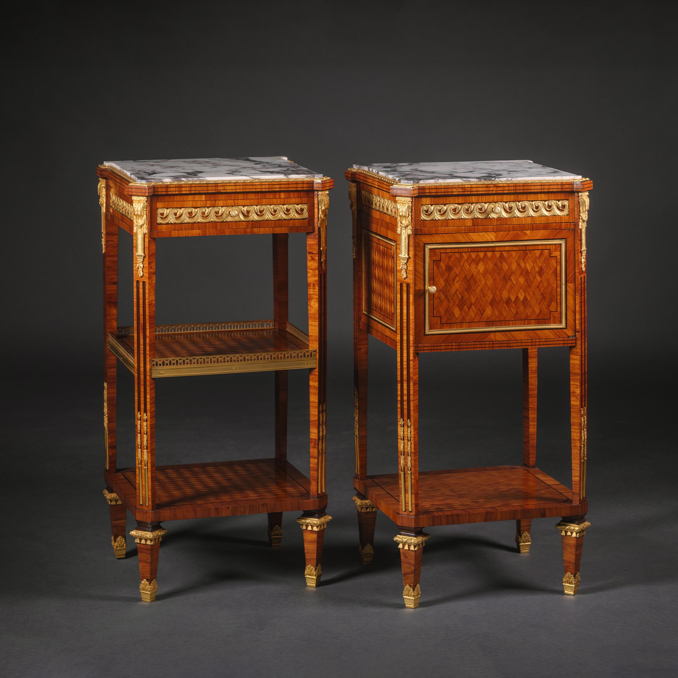 A Pair Of Louis XVI Style Gilt-Bronze Mounted Parquetry Beside Tables.

Each of fine construction with inset brêche violette marble top above a frieze inset with an entrelac ormolu mount and fronted by a drawer. One fitted with a cupboard above a