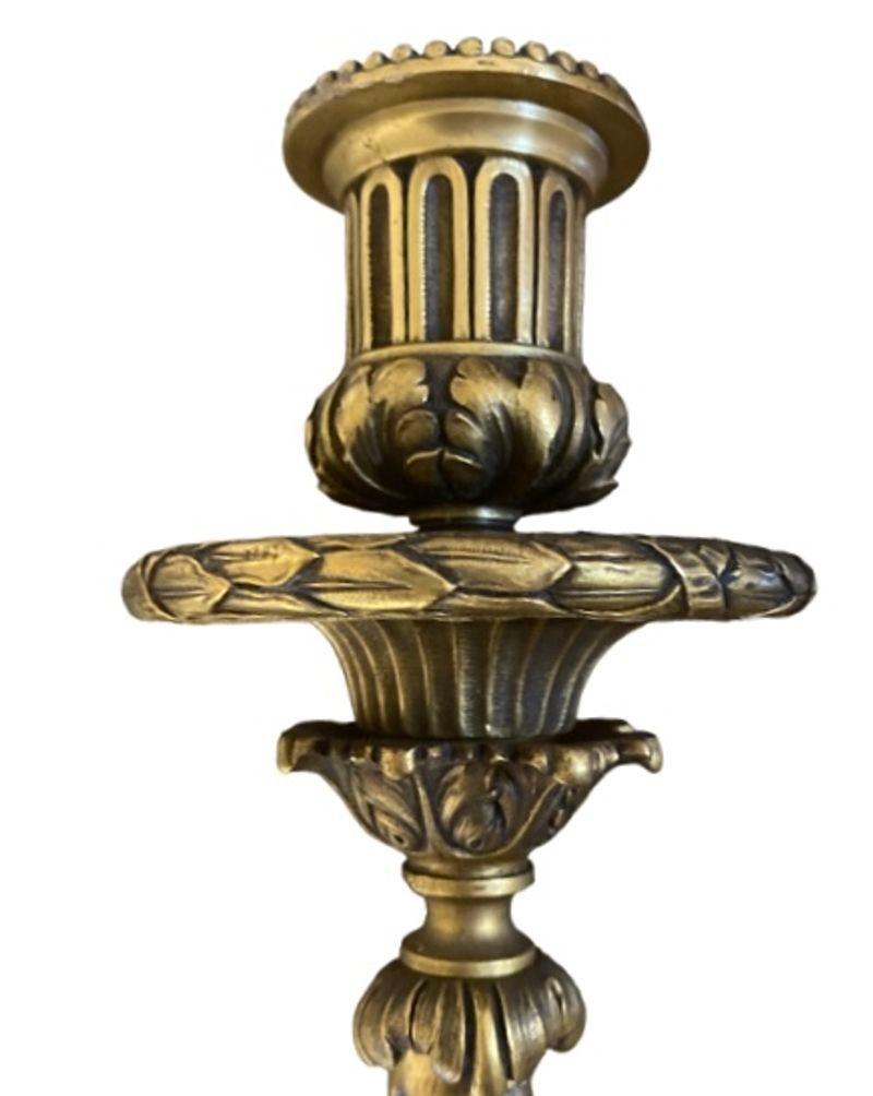 The two-arm wall lights with urns and swags above a rosette and ending with fluted tapering columns. The branches with fluted candleholders and conforming swags. Edward F. Caldwell & Co. was America's premier producer of lighting and other metal